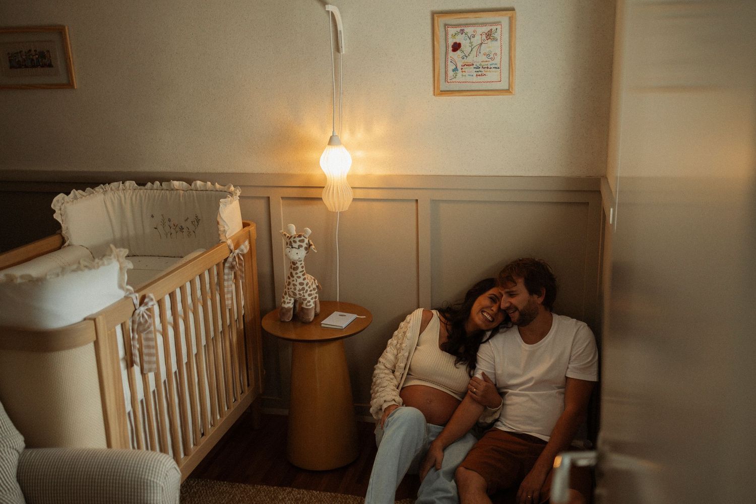 Cozy nursery room interior with warm lighting and wooden crib.