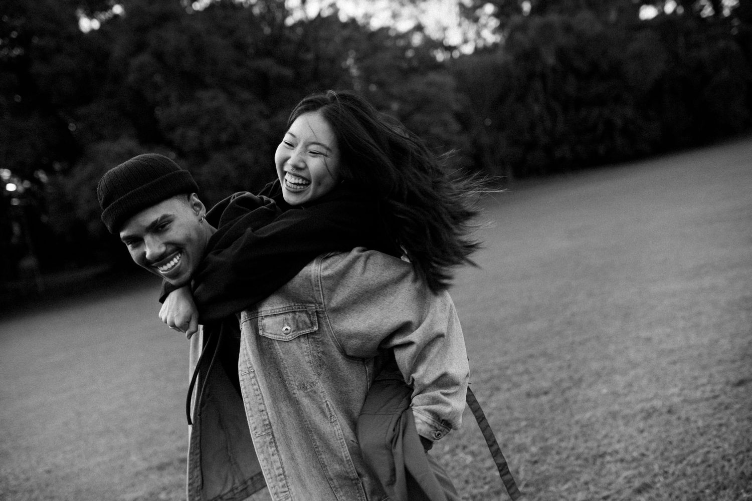 Black and white candid shots of people sharing genuine laughs together.