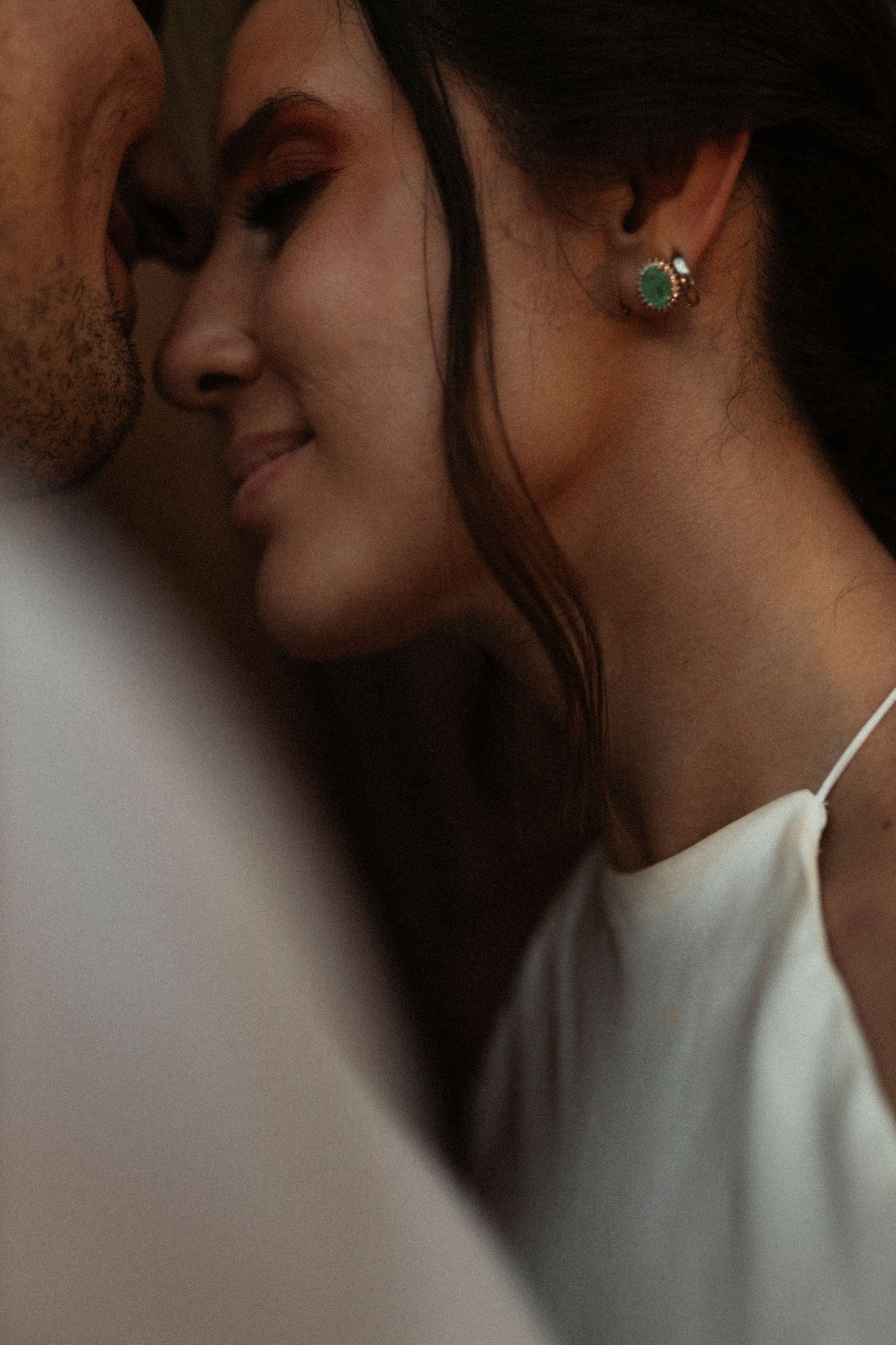 Intimate close-up portrait sequence in dramatic lighting and shadows.