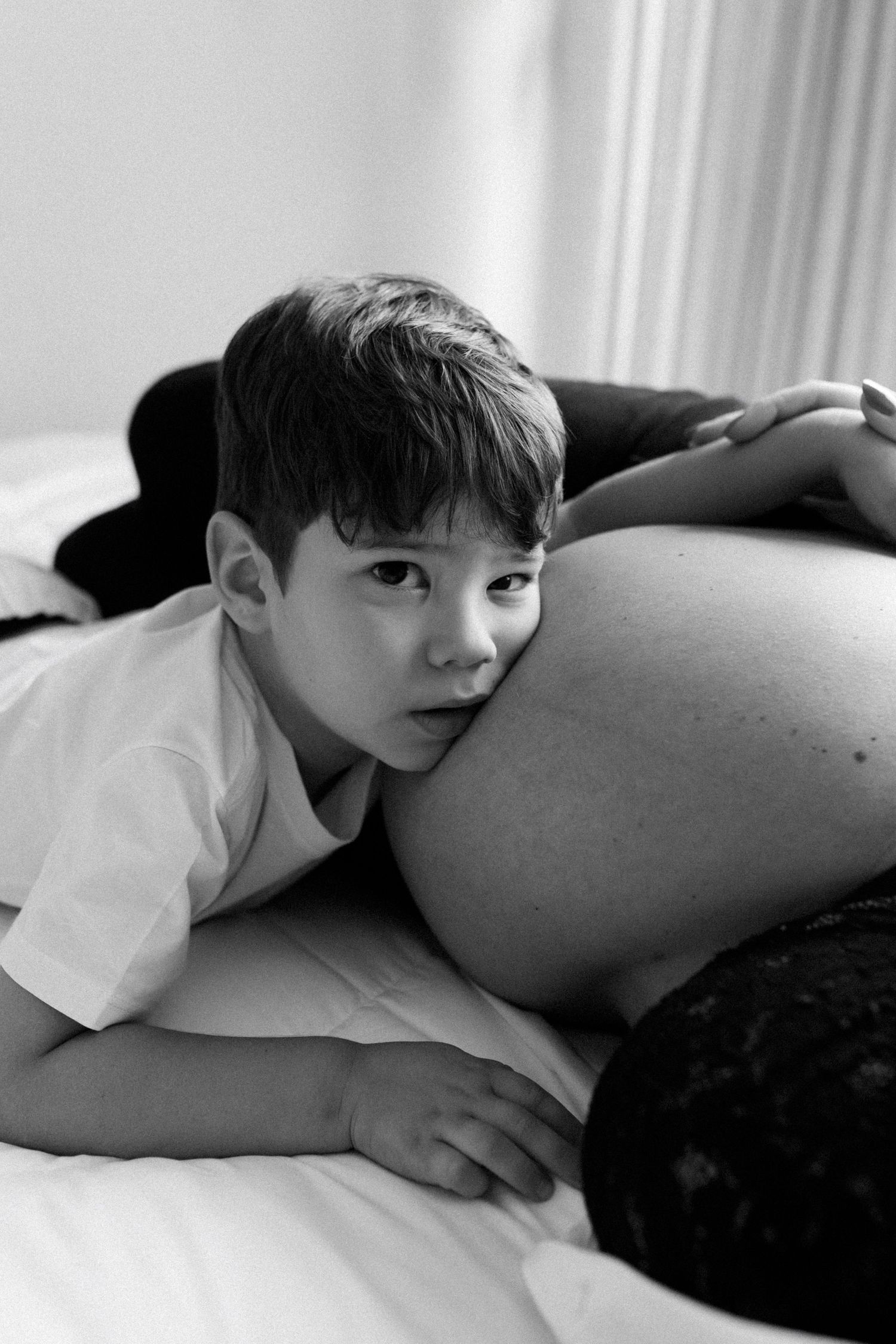 Black and white intimate maternity photo series showing tender moments.