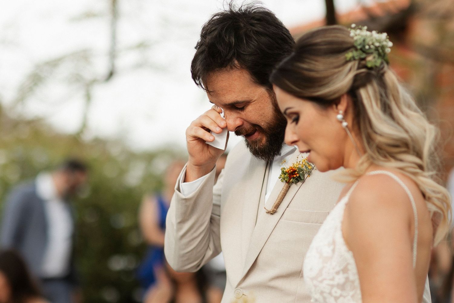Emotional wedding day moment captured in black and white as couple shares tears of joy during their ceremony.