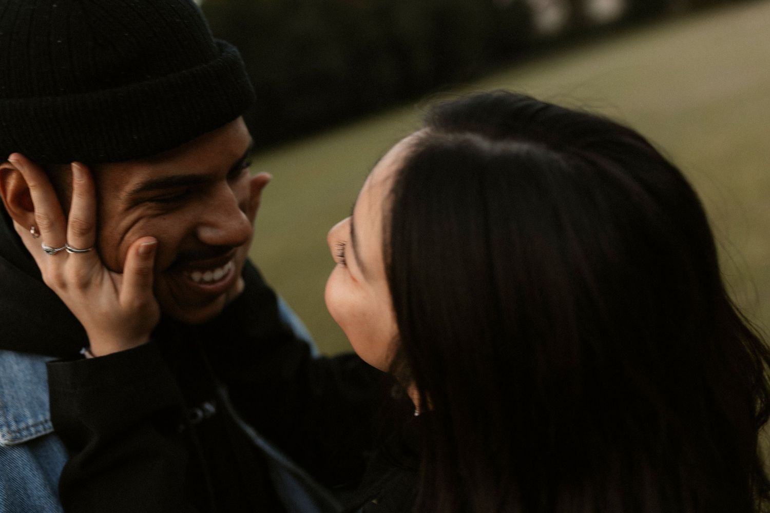 Candid moments of laughter and joy captured outdoors in natural lighting.