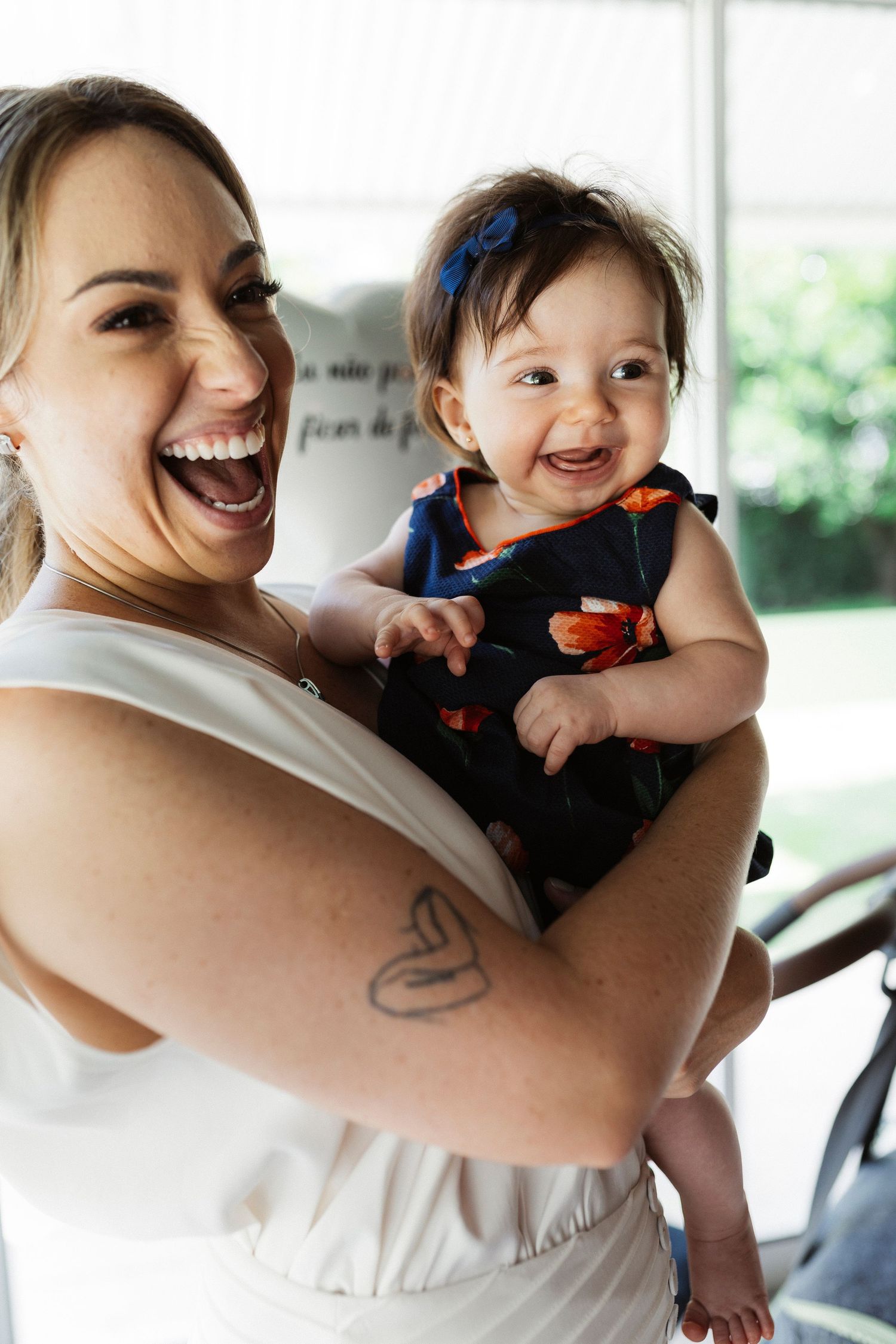 Joyful candid moments of parent and child laughing and playing together in natural light.