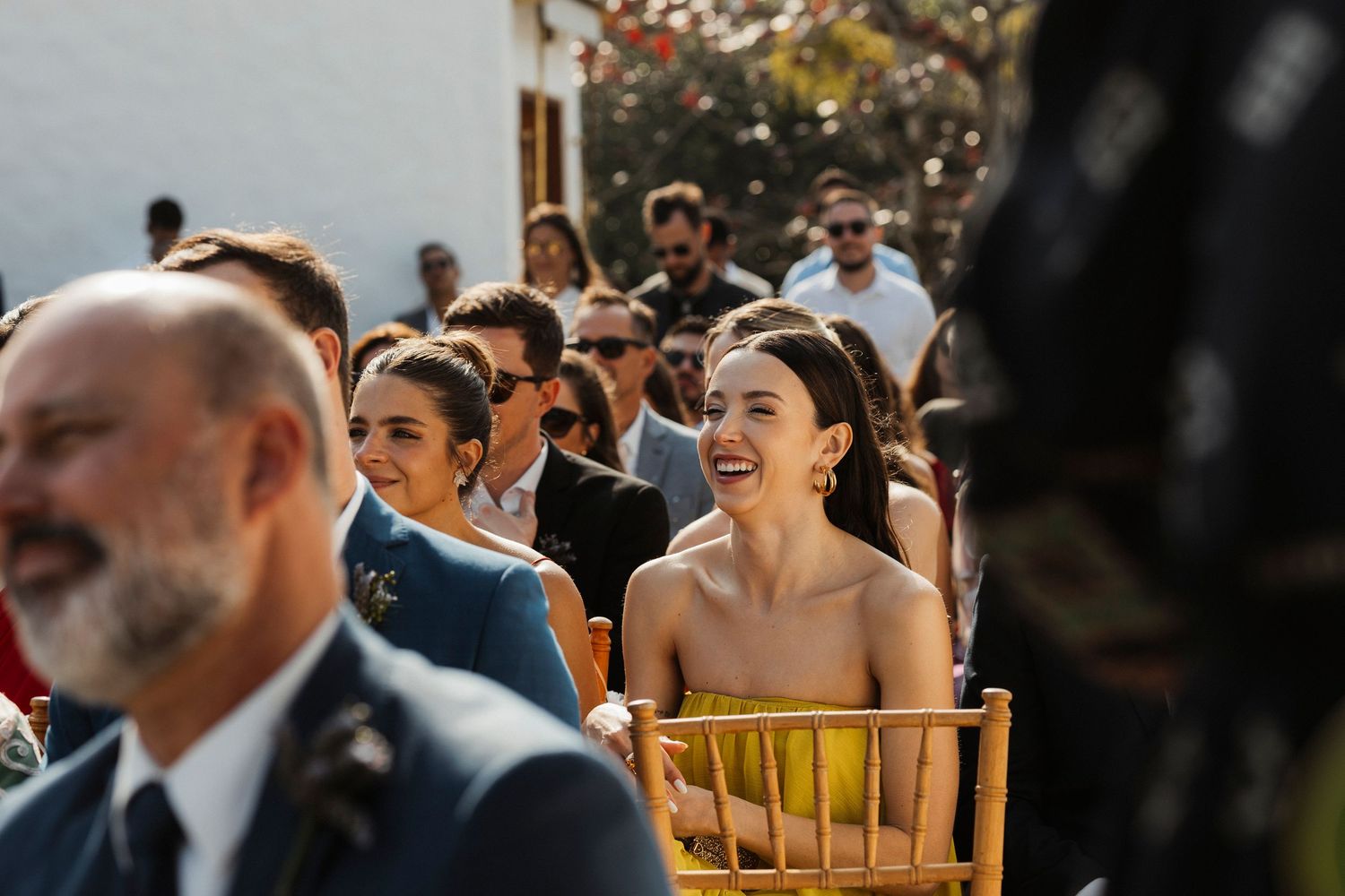 Wedding reception guests seated at tables during an outdoor celebration.
