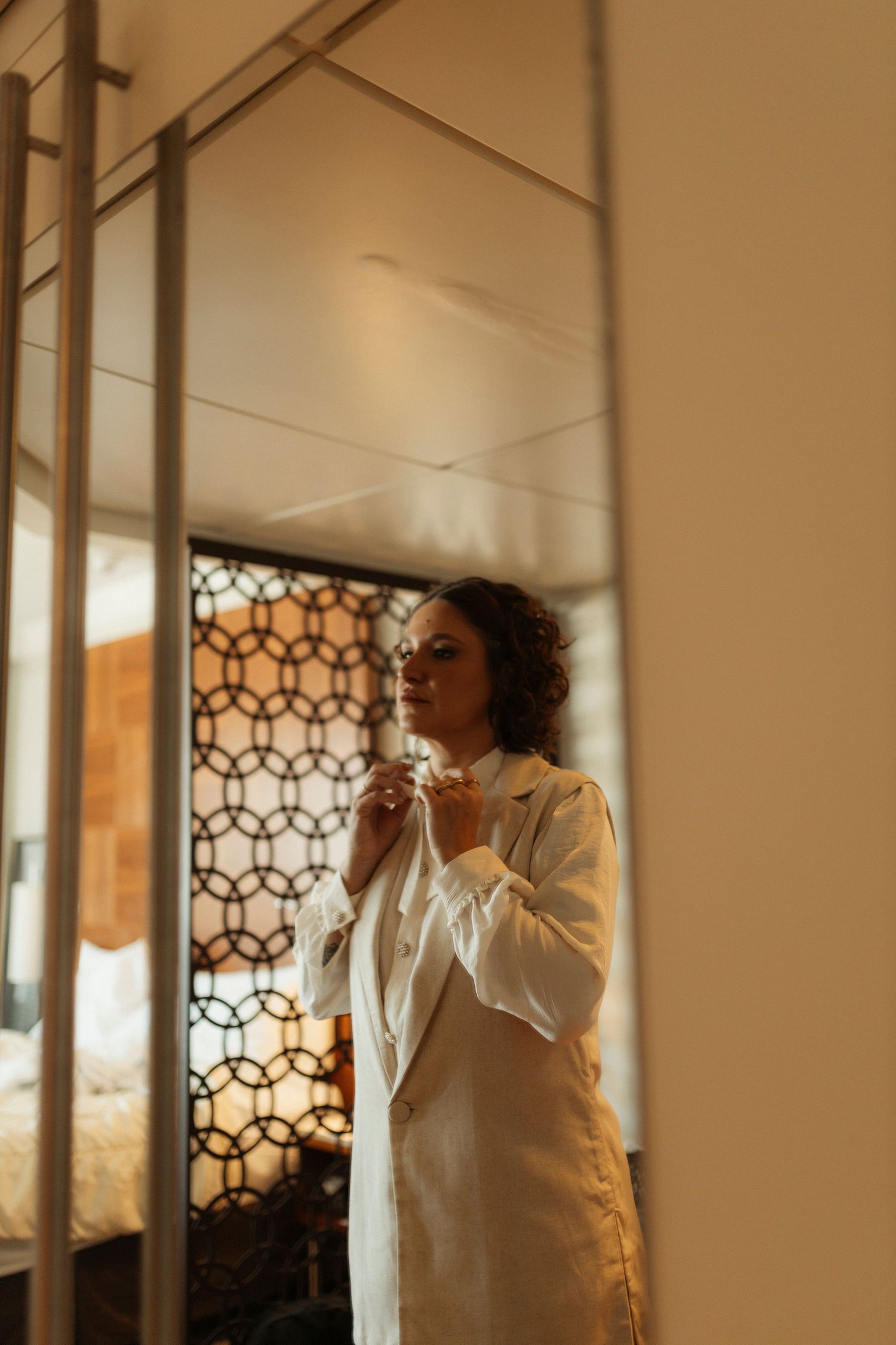 Reflective mirror sequence showing a figure in white clothing against warm lighting.
