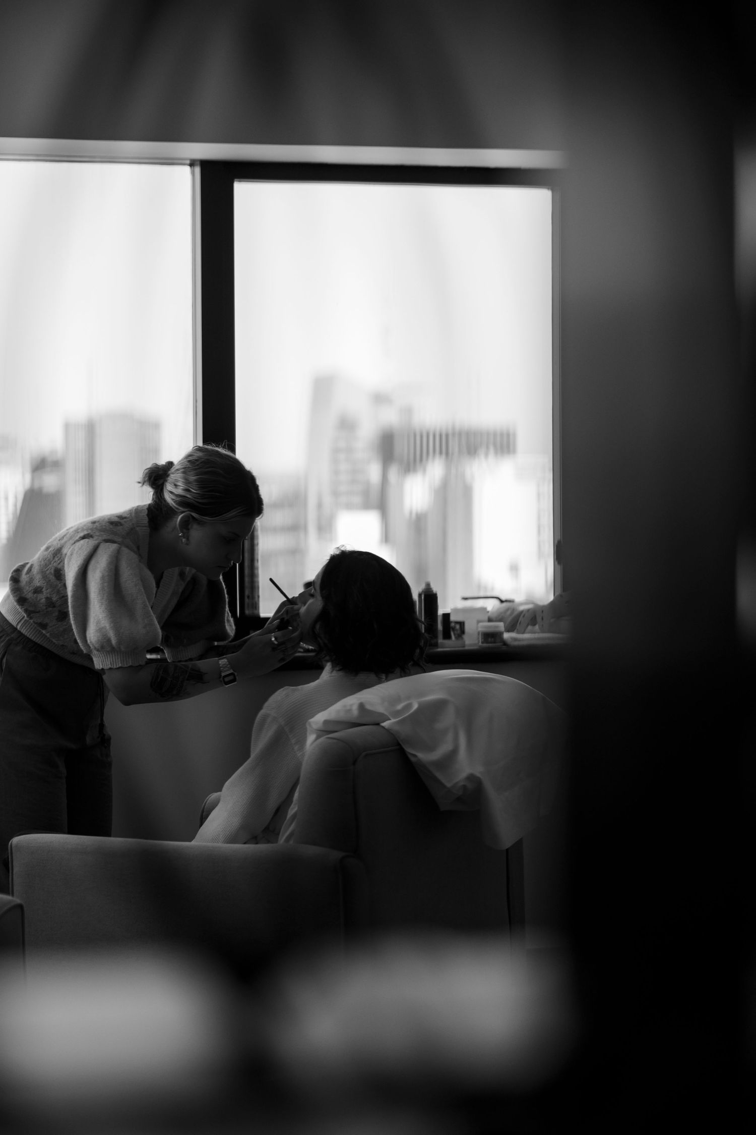 Intimate black and white sequence captured through window reflections in urban setting.