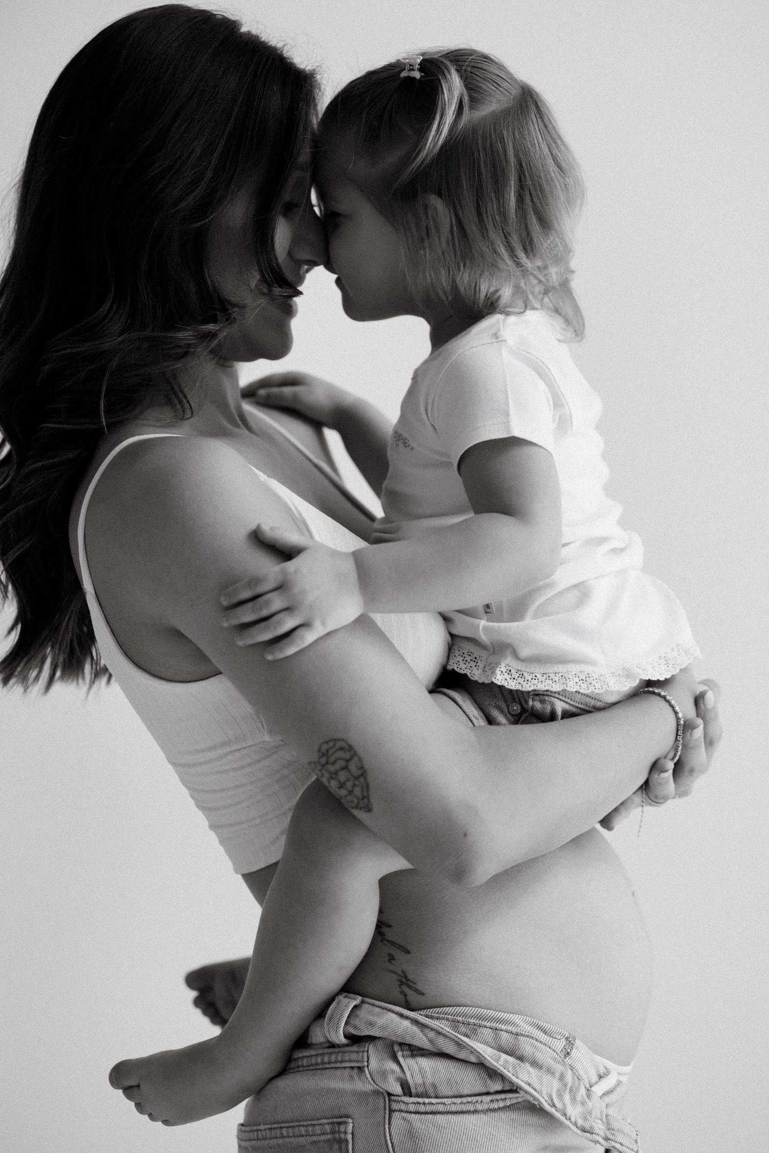 Black and white photo series showing intimate dance-like poses between two people in casual clothing.