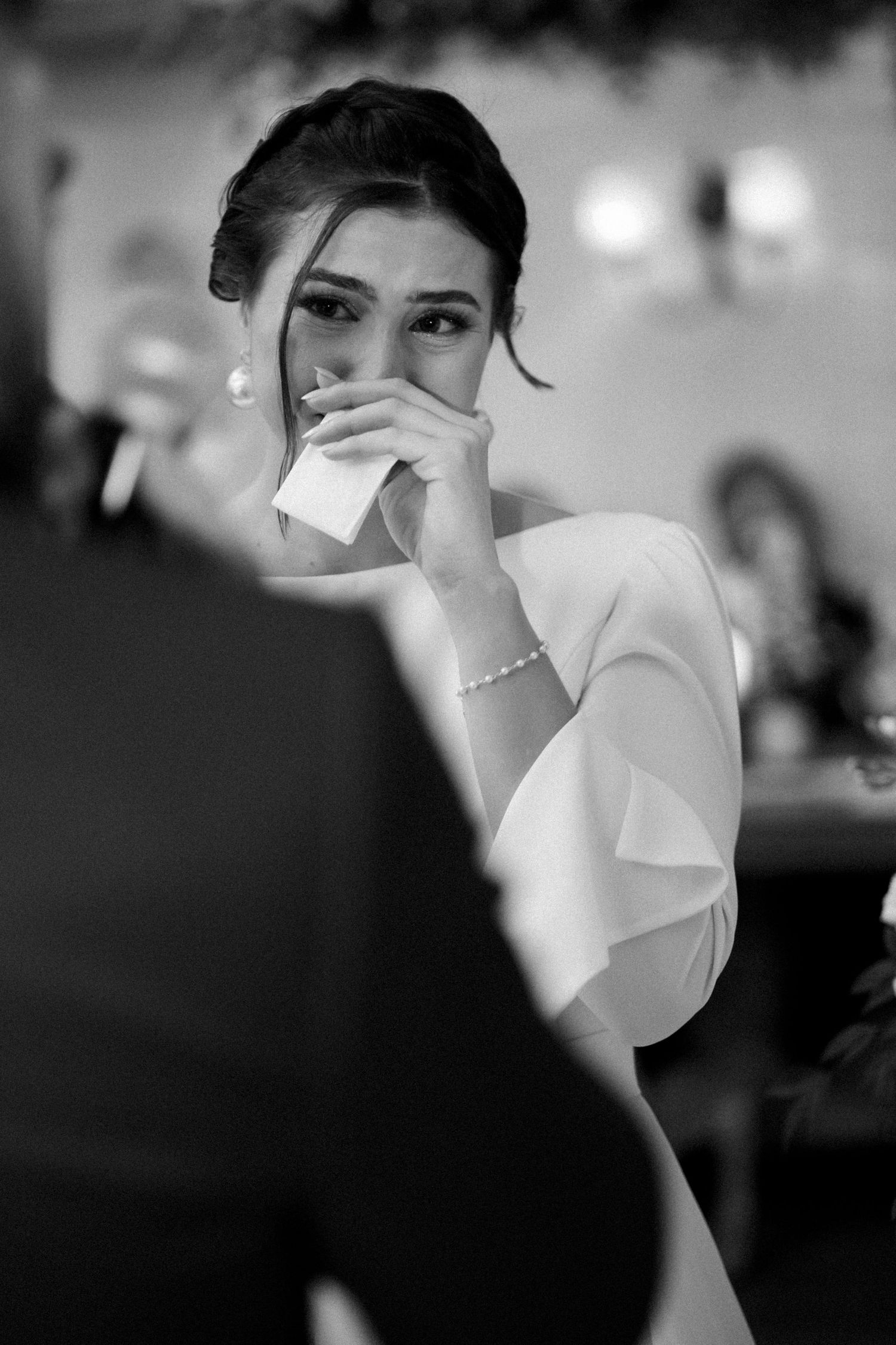 Black and white close-up shots showing emotional moments during a wedding celebration.