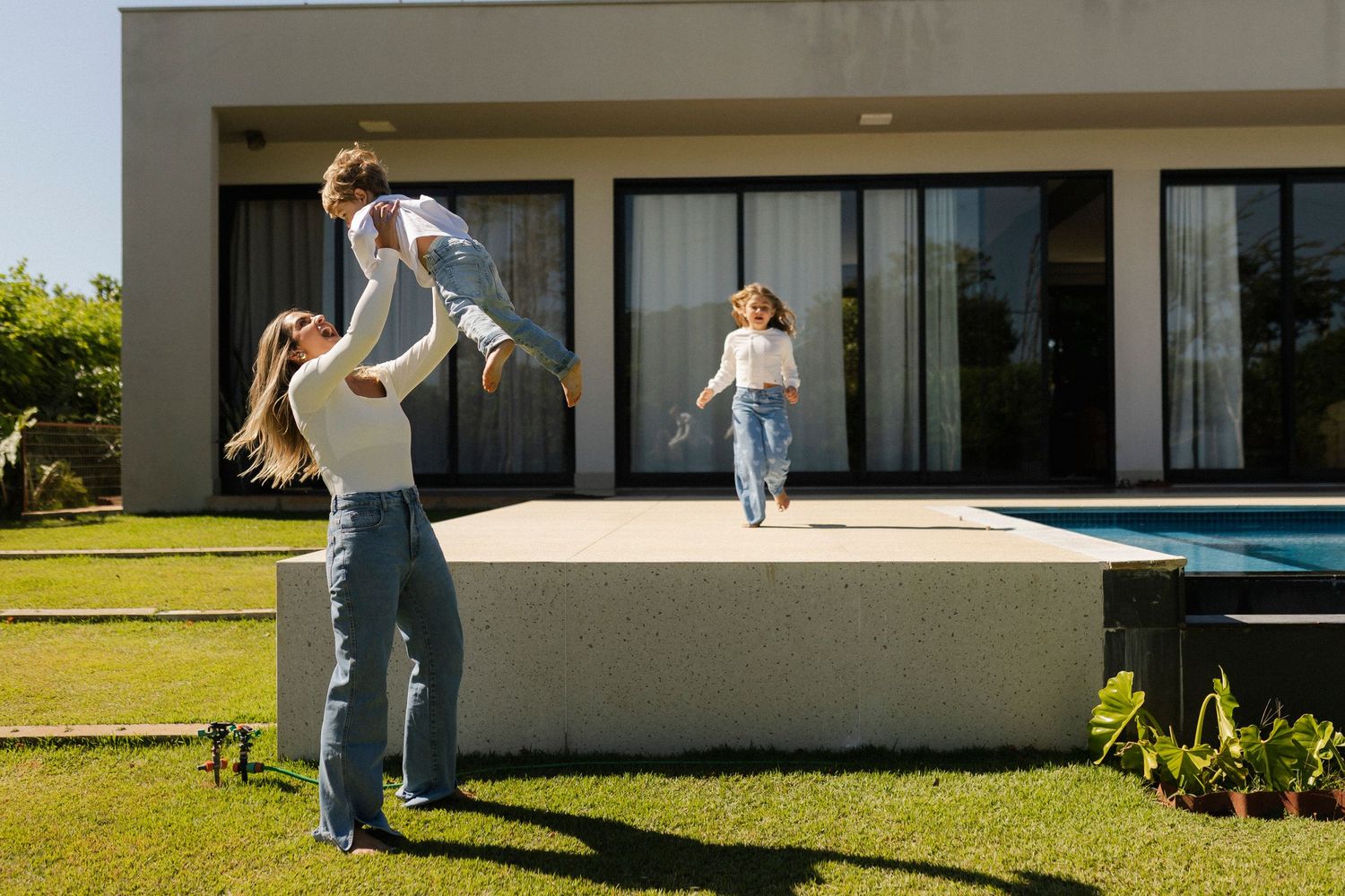 People enjoying leisure time outside a contemporary minimalist house.