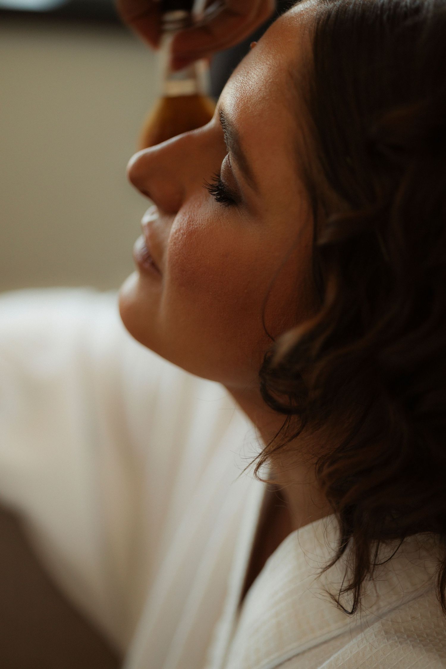 Close-up profile shot in soft lighting showing gentle contemplation.