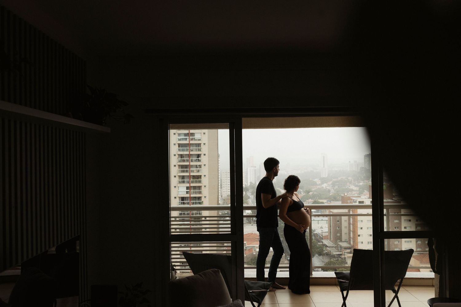 Silhouettes of people framed in windows against bright backlighting.