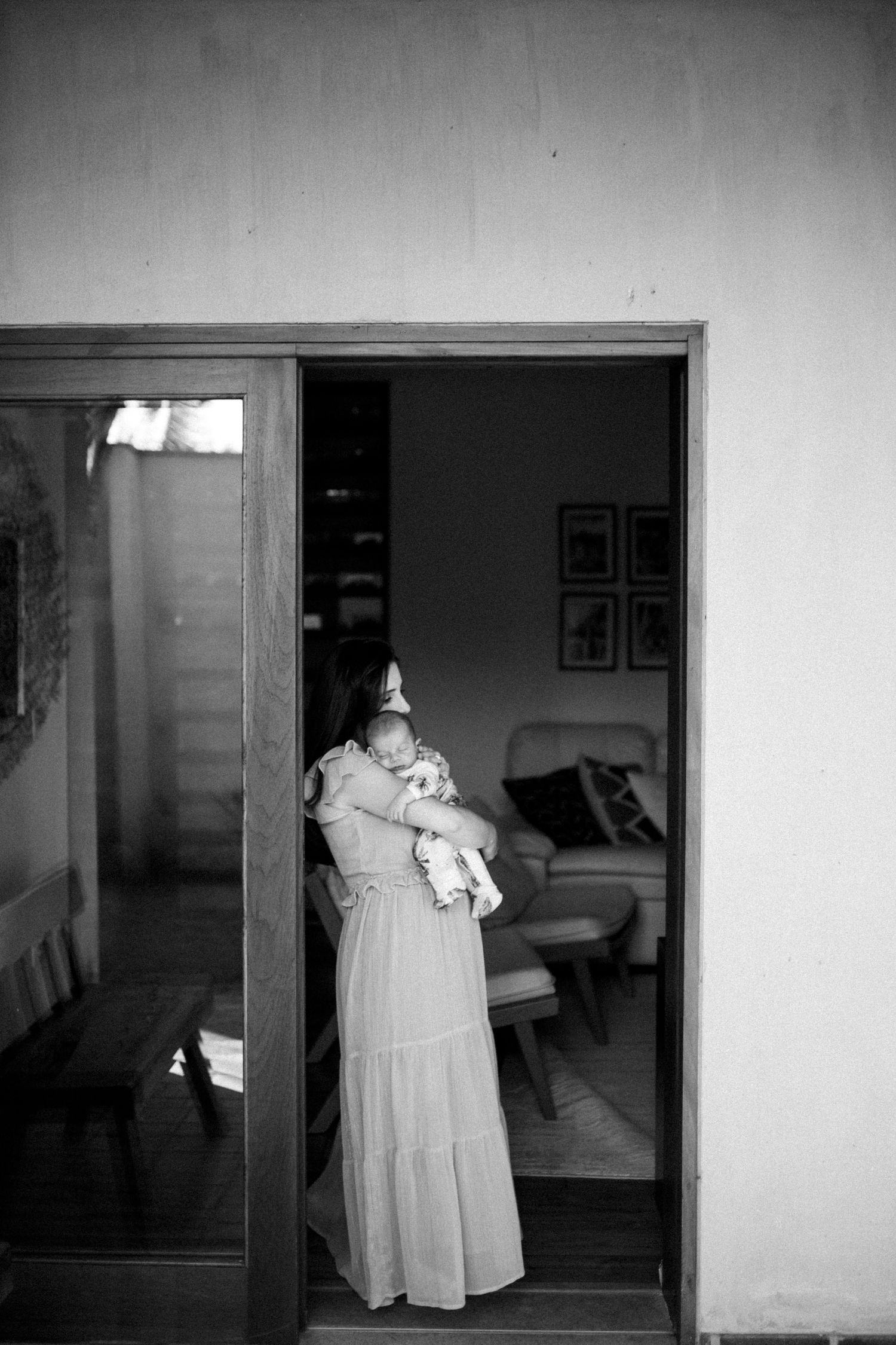Black and white series showing movement through doorway with flowing dress.