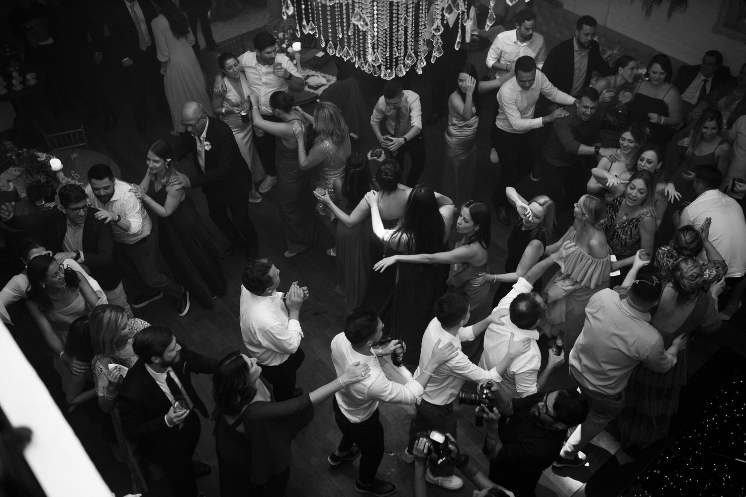 Overhead view of wedding reception dance floor filled with celebrating guests.