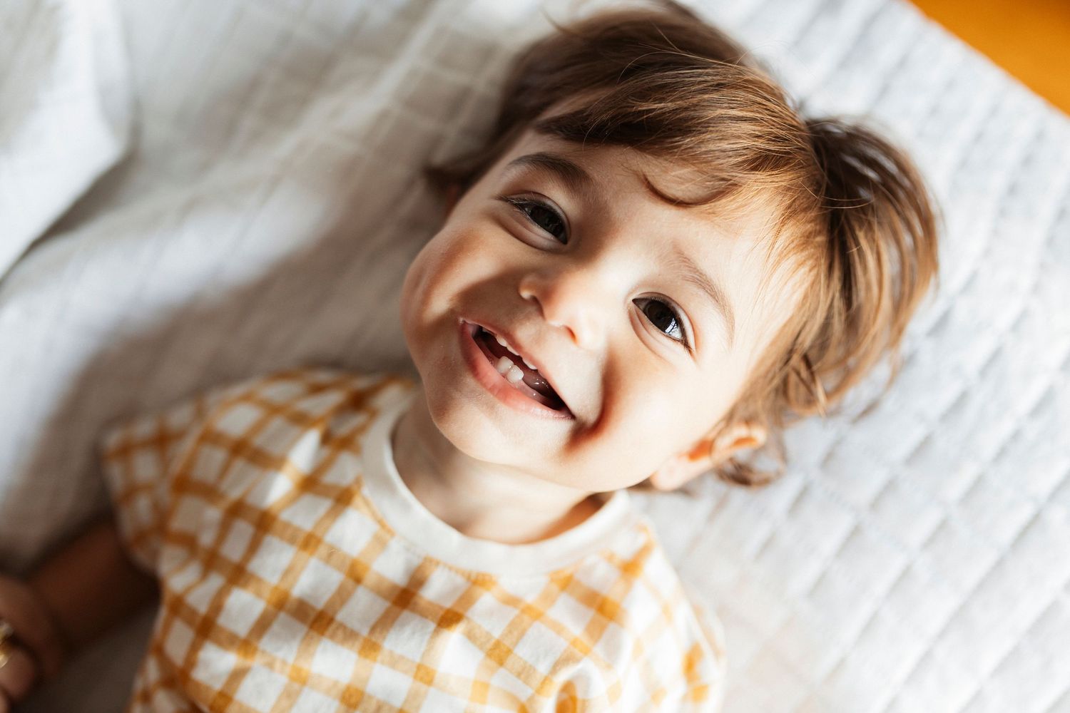 Close-up portrait series showing bright smiles and happiness against white background.