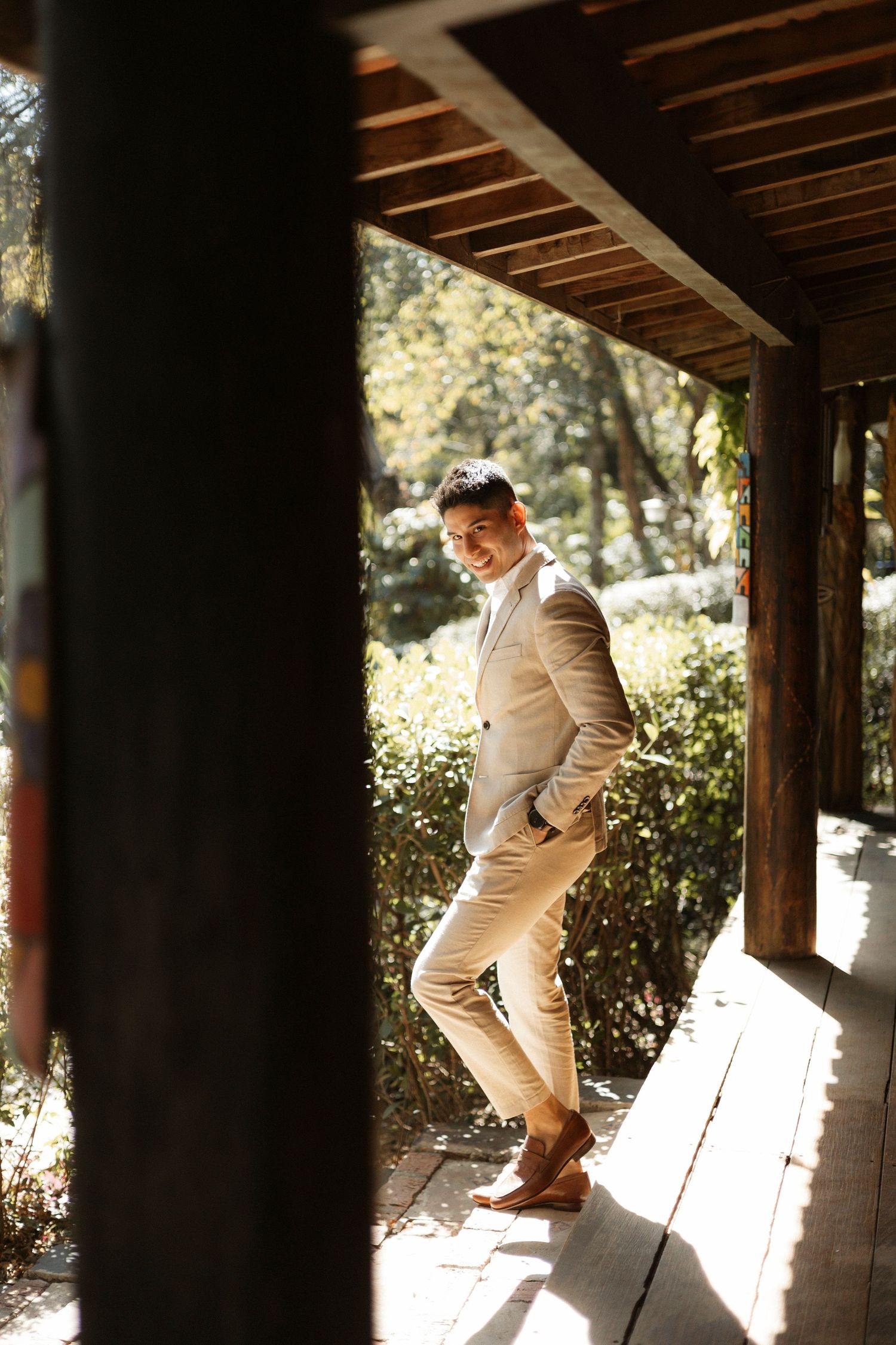 Sequence showing person in light colored outfit moving across wooden porch in sunlight.