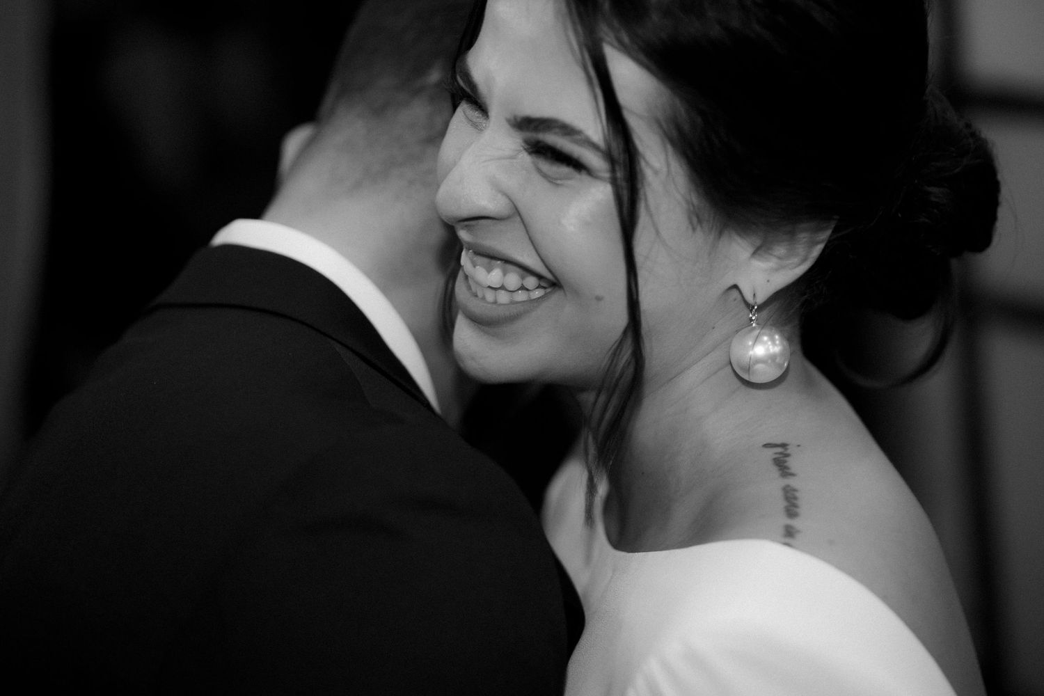 Intimate black and white wedding portrait showing genuine emotion and connection.