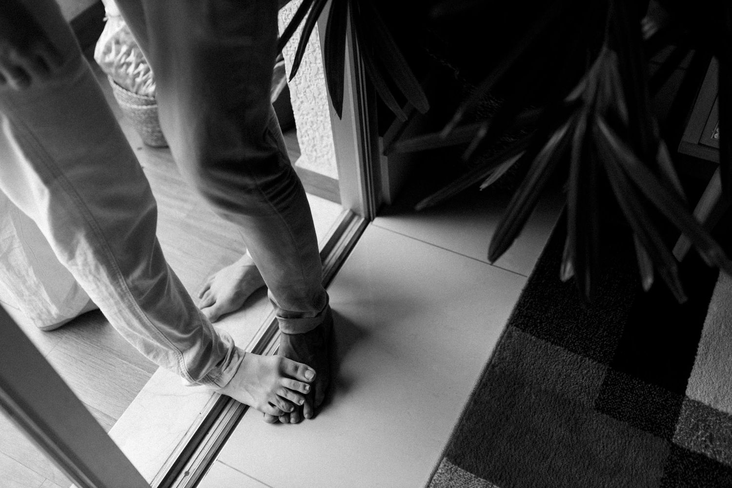 Low angle view of feet and legs near a window.
