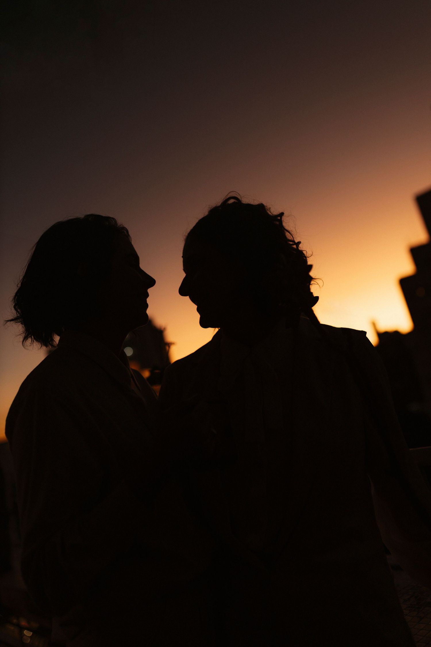 Silhouettes of people against a warm sunset sky creating dramatic shadows and lighting.