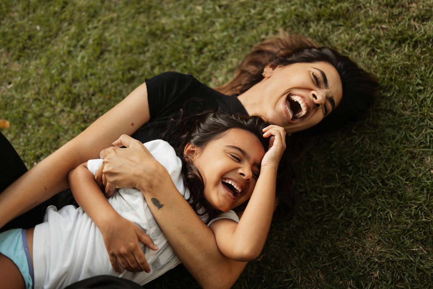 Playful moments captured in a grassy backyard setting.