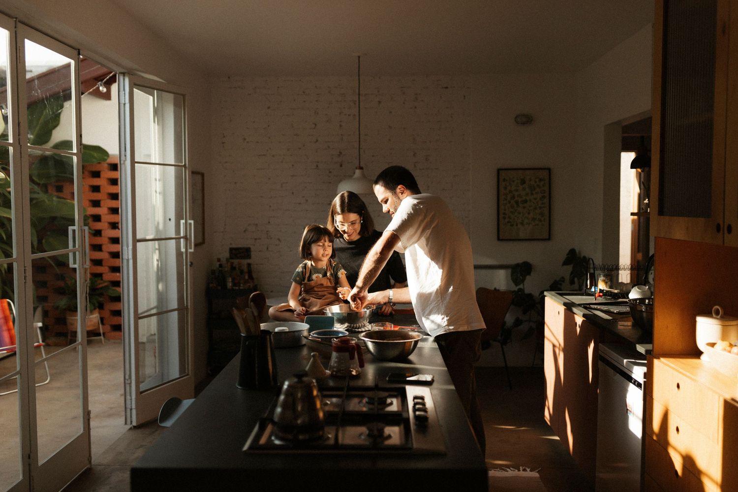 Sunlit interior room with dramatic shadows cast across white brick walls.