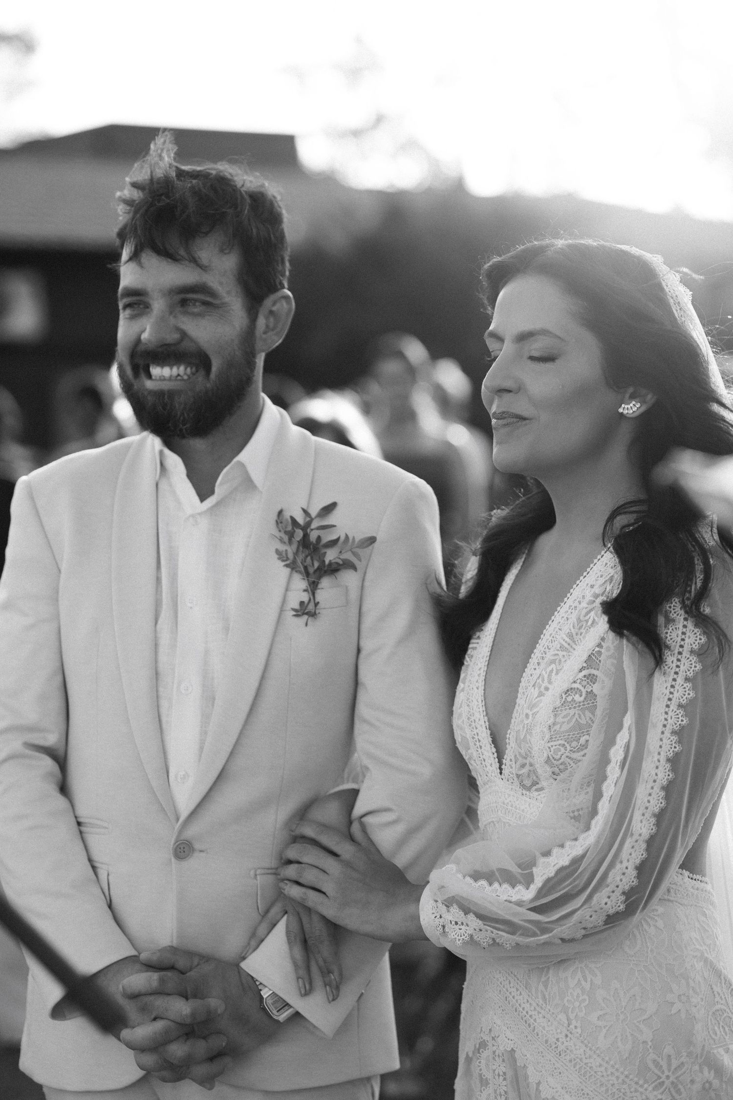 Candid black and white shots of couple sharing joyful laughter during wedding celebration.