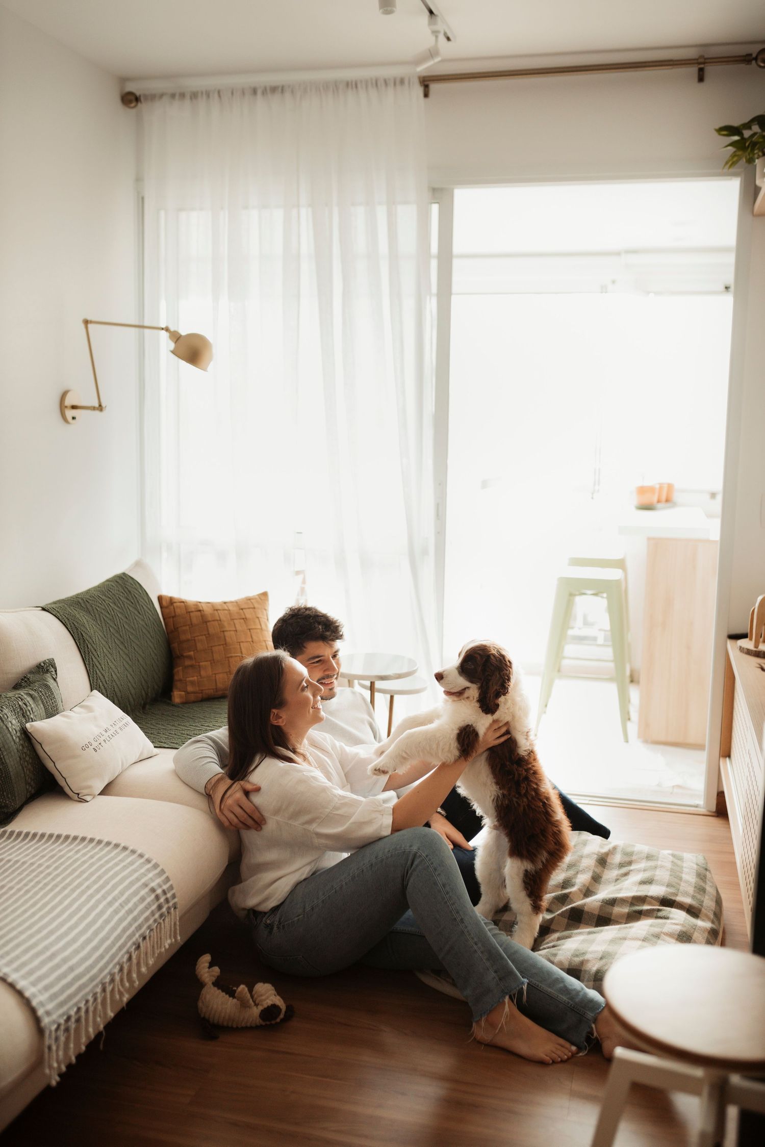 Couple relaxing and lounging together in a bright, minimalist white bedroom.