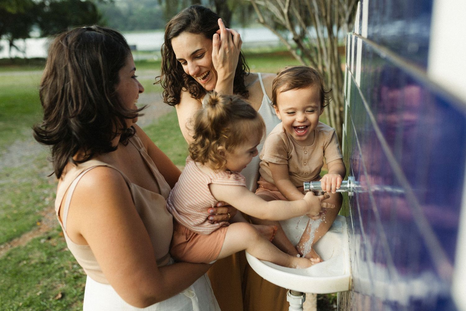 Tender family moments shared on a wooden deck overlooking a serene lake.