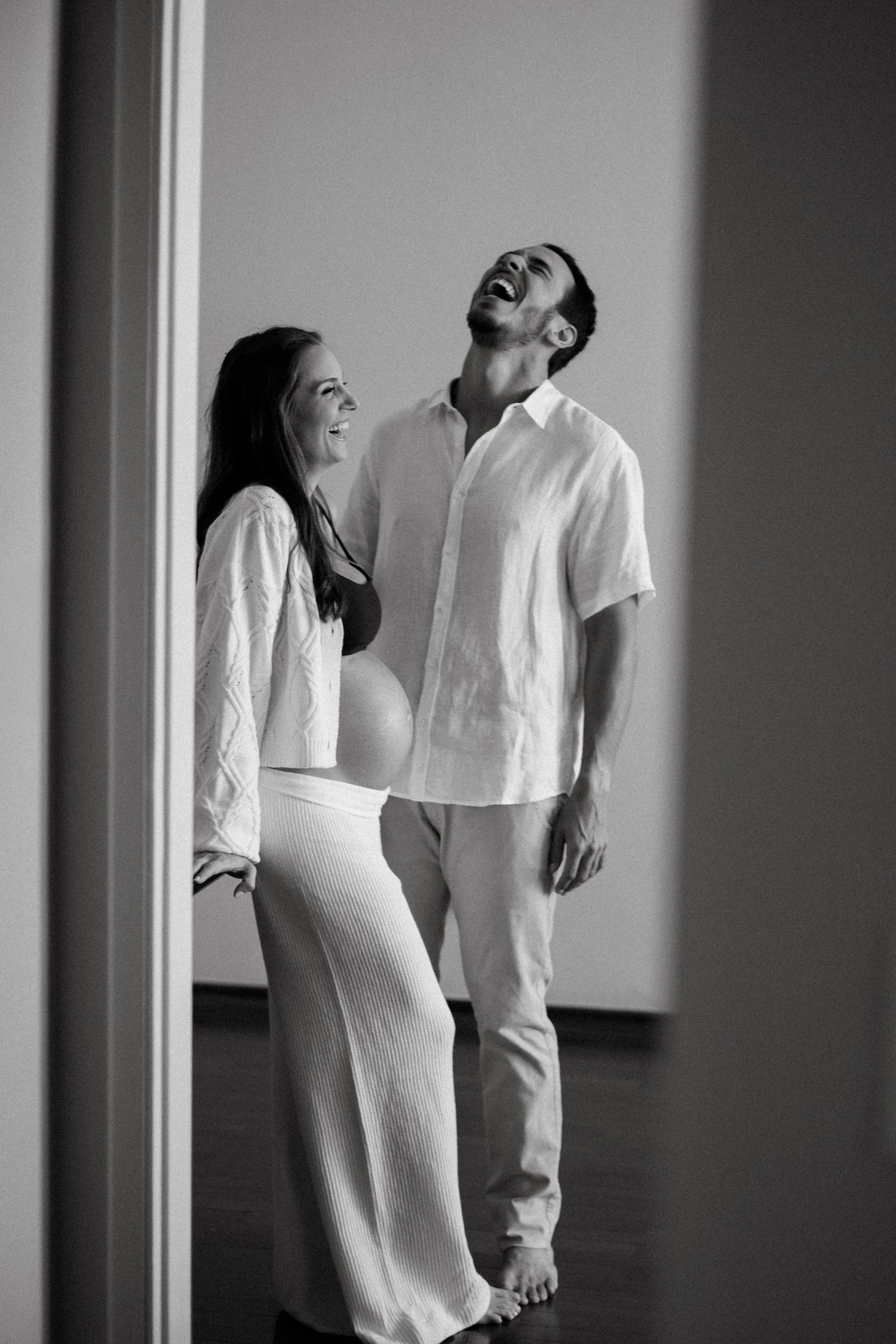 A series of black and white photographs showing figures in white clothing moving expressively against a dark background.