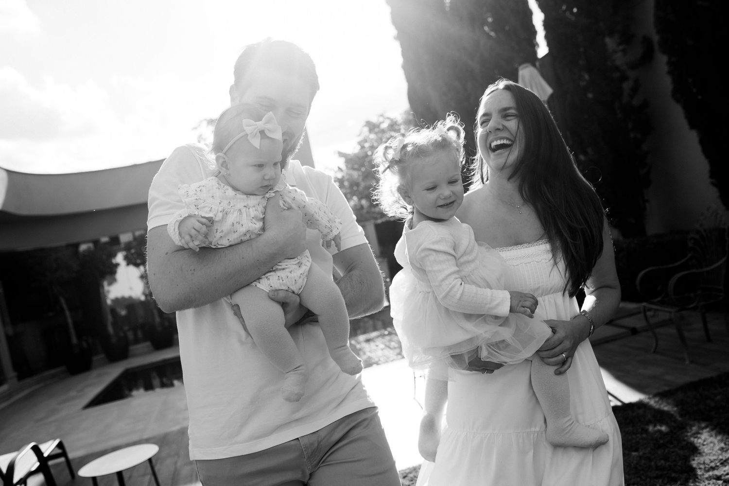 Black and white outdoor family photoshoot with soft natural lighting.