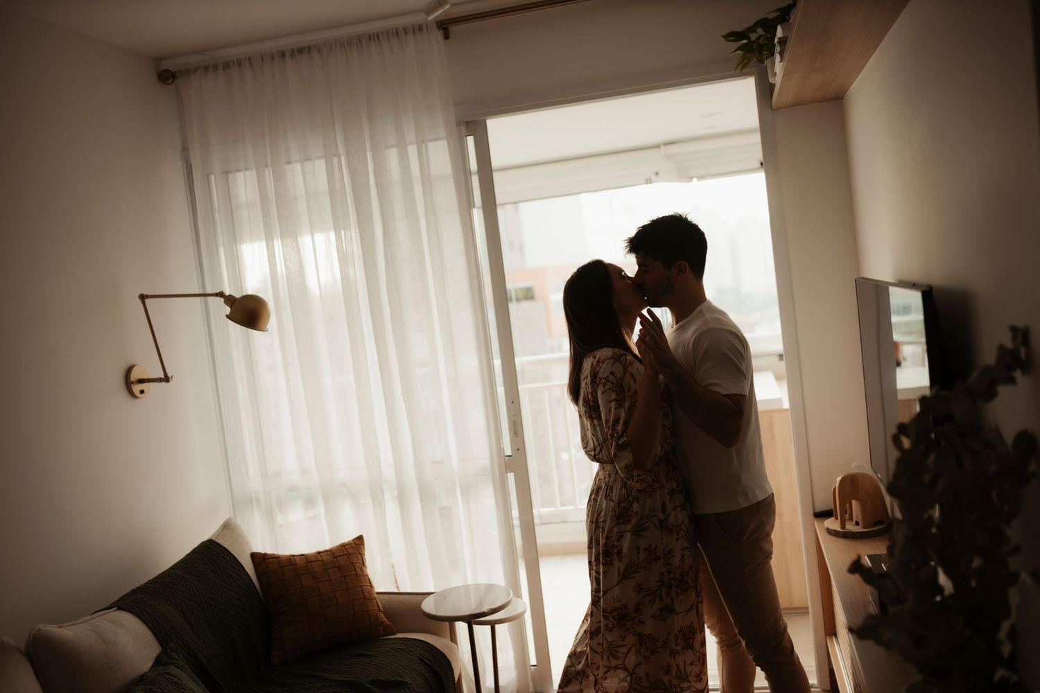 Soft, intimate home photography with natural window light and curtains.
