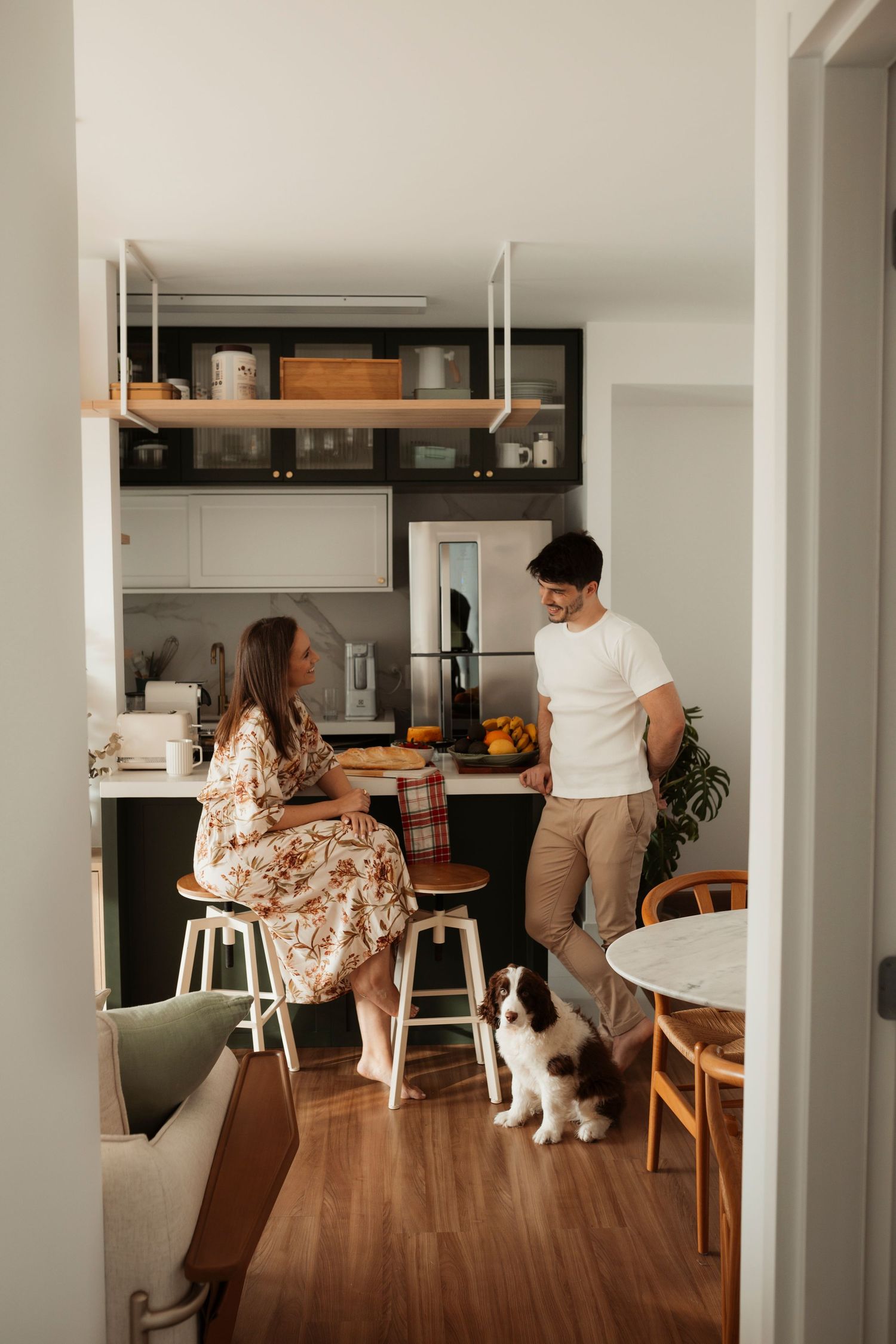 A modern home interior with wooden floors and white walls featuring casual lifestyle moments.