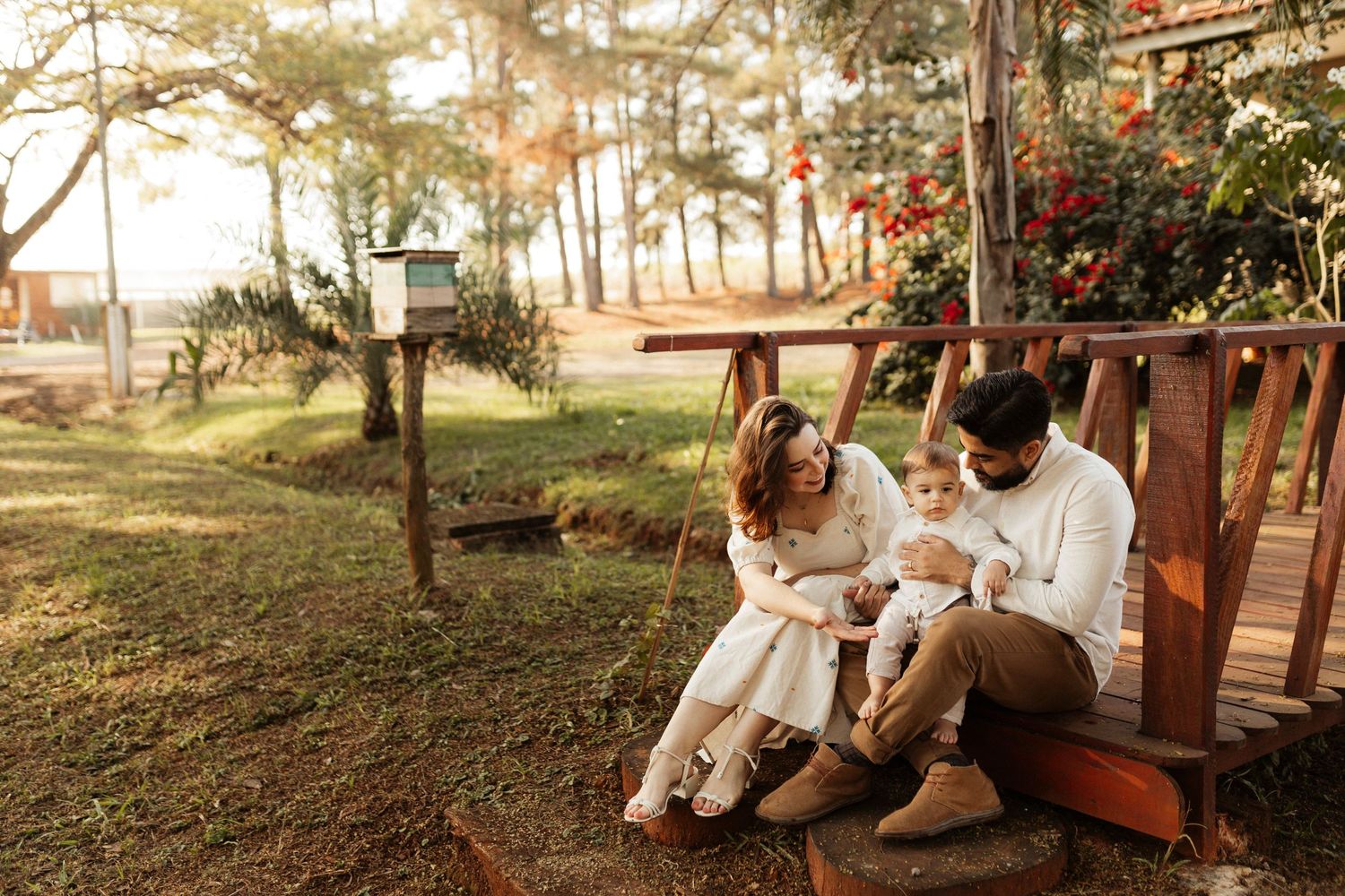 A couple enjoys a romantic outdoor swing set in a park during golden hour.