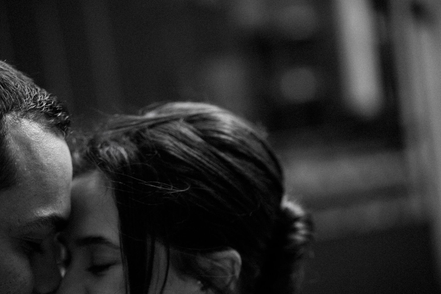 Artistic black and white close-up shots capturing romantic moments between a couple.