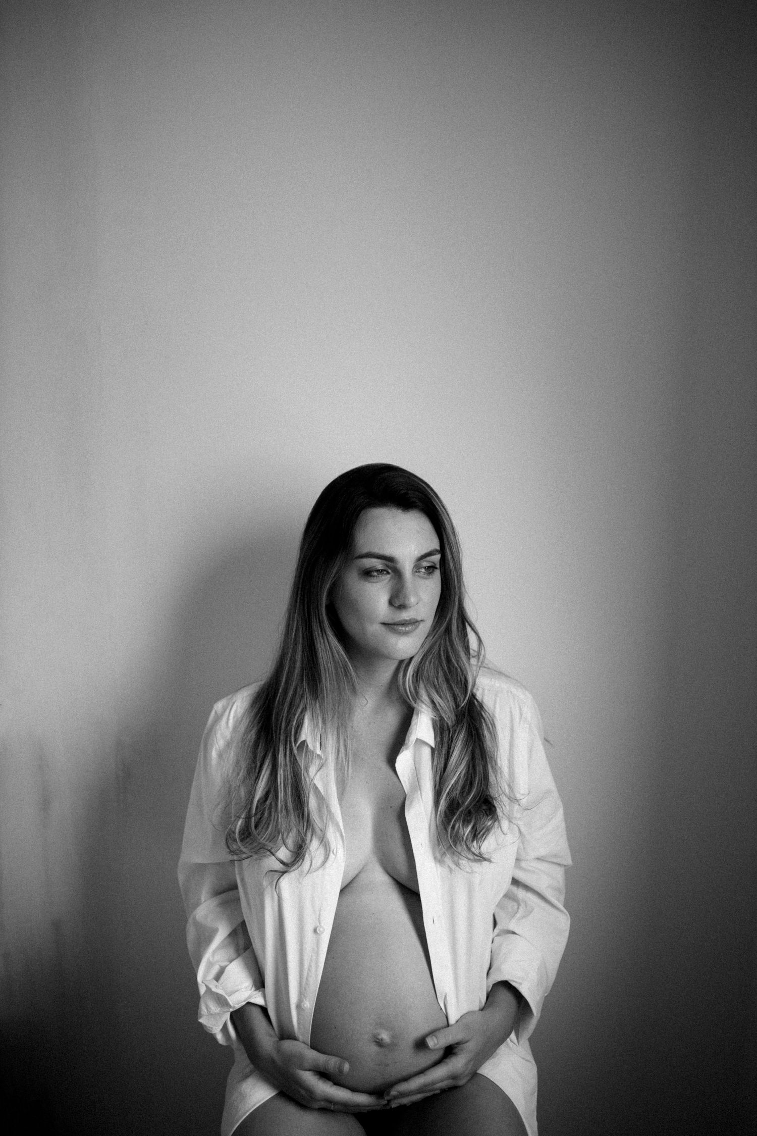 Artistic black and white portrait series featuring a white shirt against dark background.