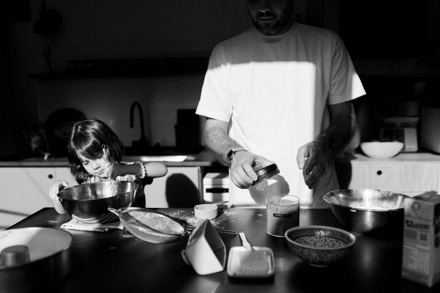 Black and white panoramic sequence showing a dining scene with dramatic lighting.
