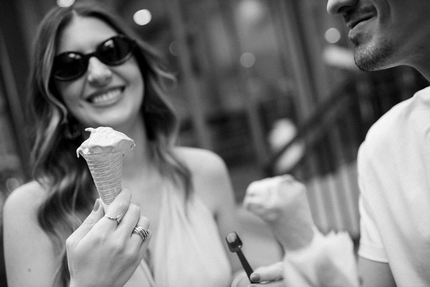 Black and white candid shots showing joyful laughter and connection.