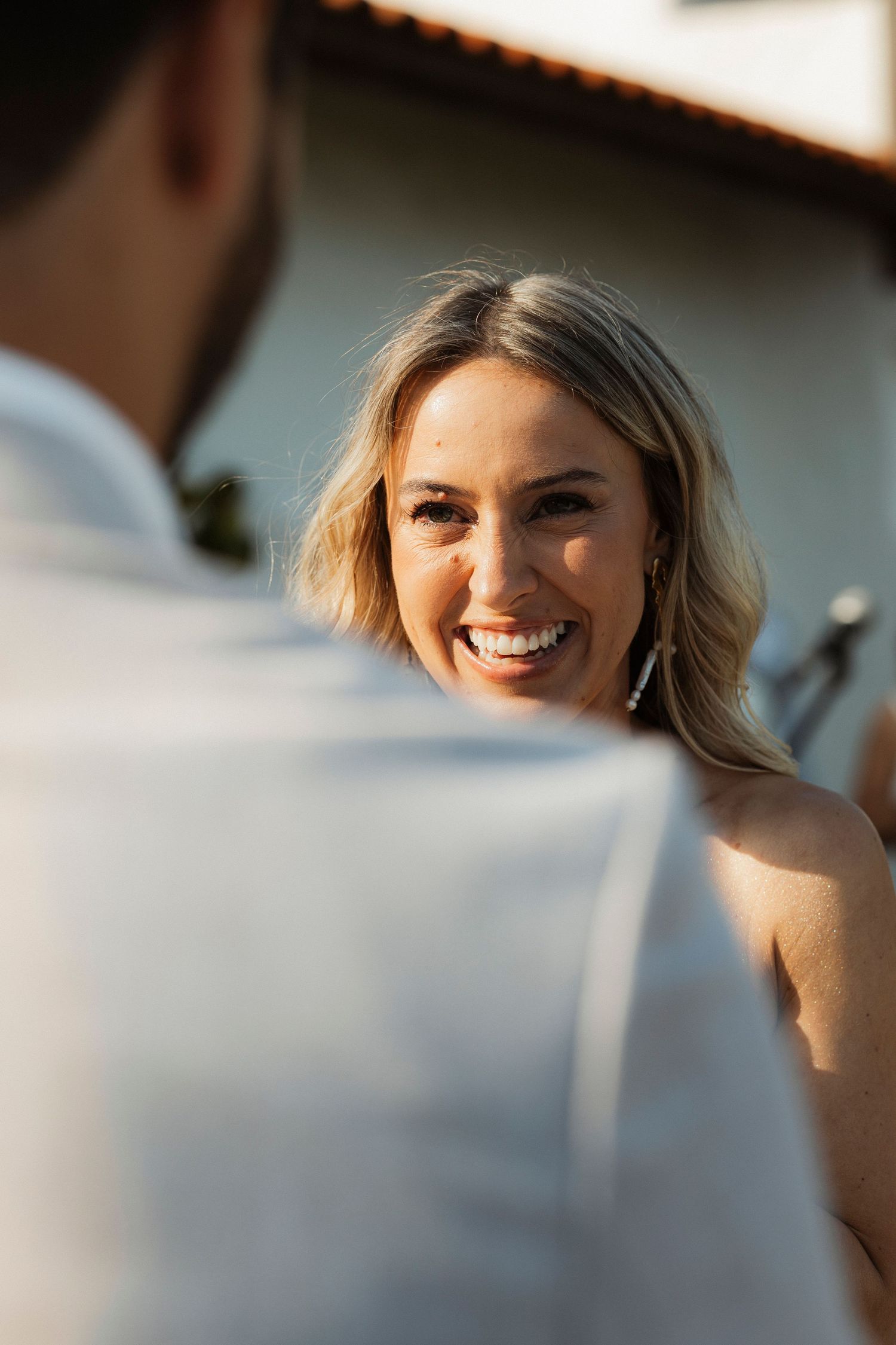 A candid moment captured during a sunset wedding celebration.