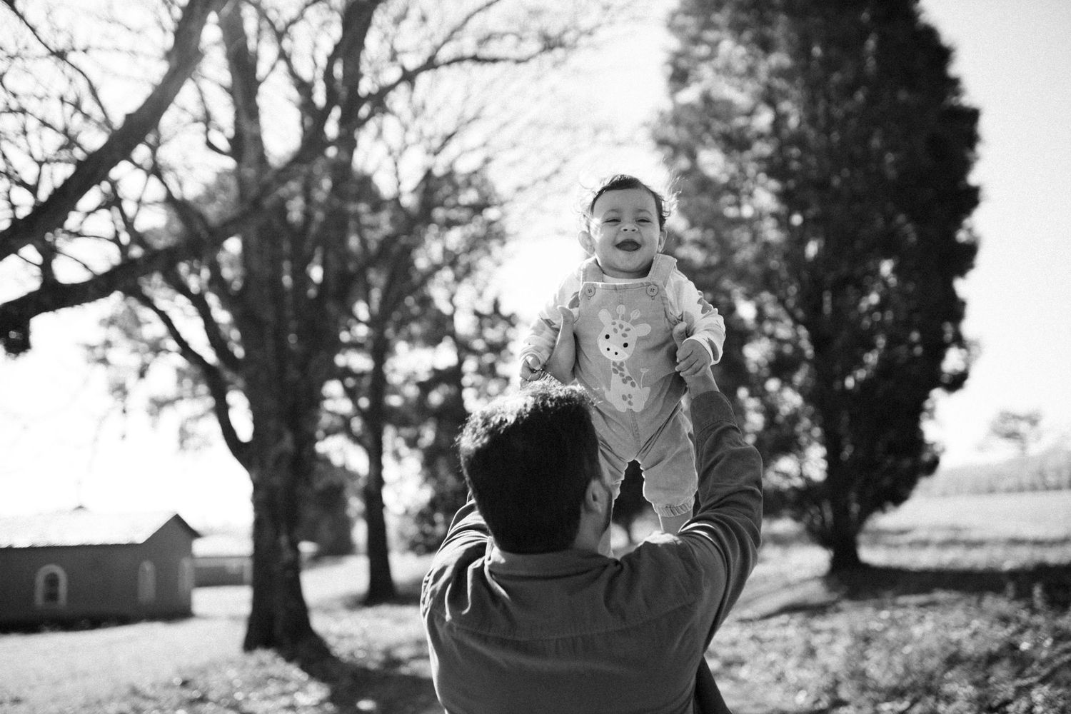 Black and white outdoor portrait series showing joyful expressions.