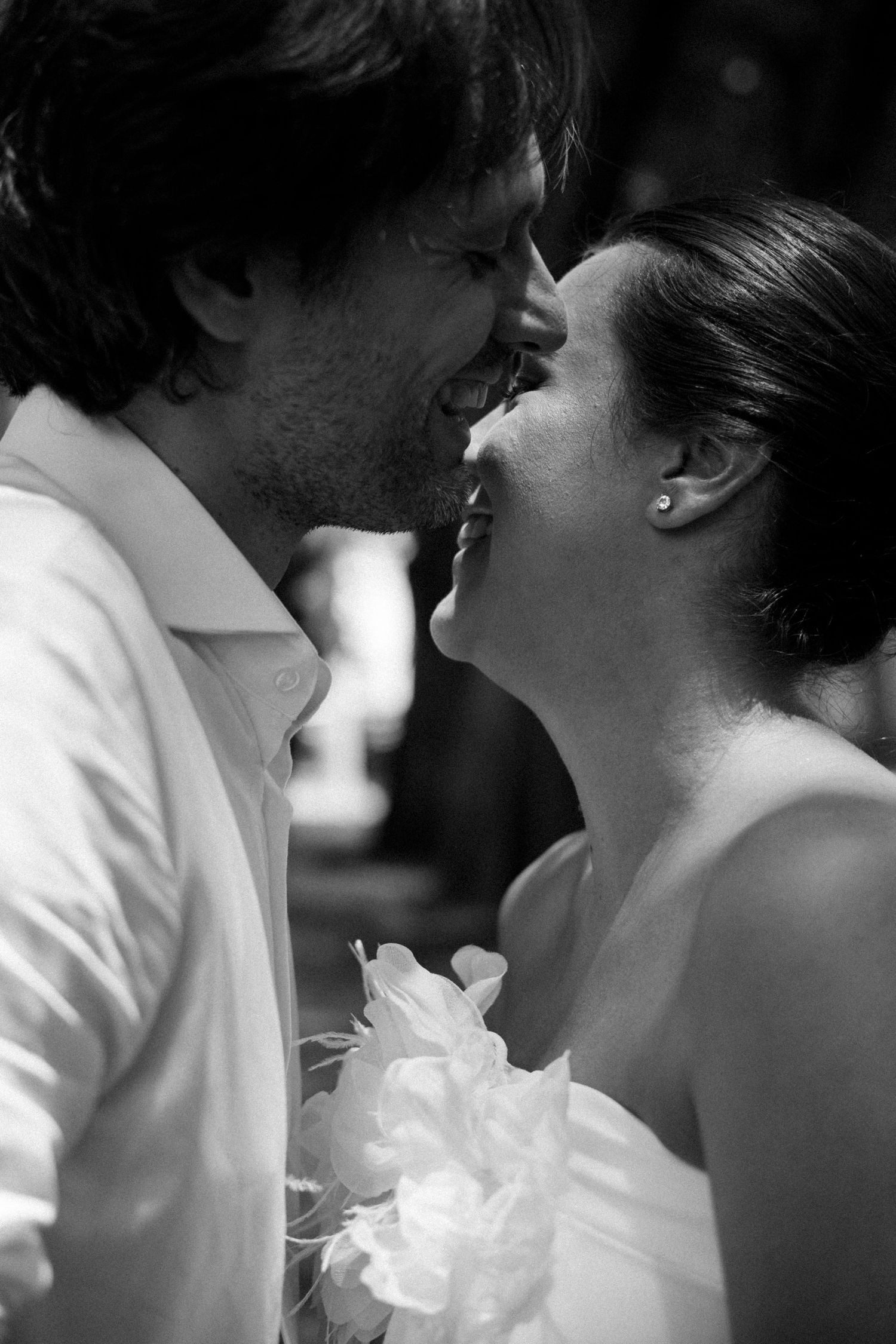 Intimate black and white close-up of a wedding couple's tender moment.