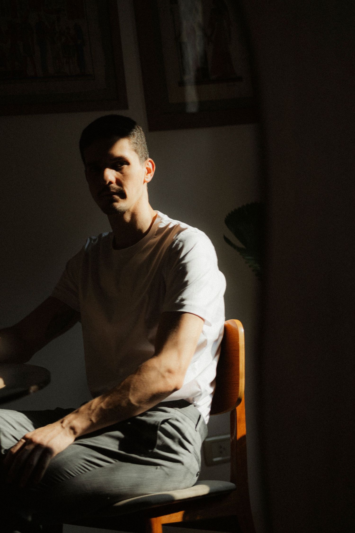 Dramatic side profile portraits in dark lighting showing contemplative expressions.