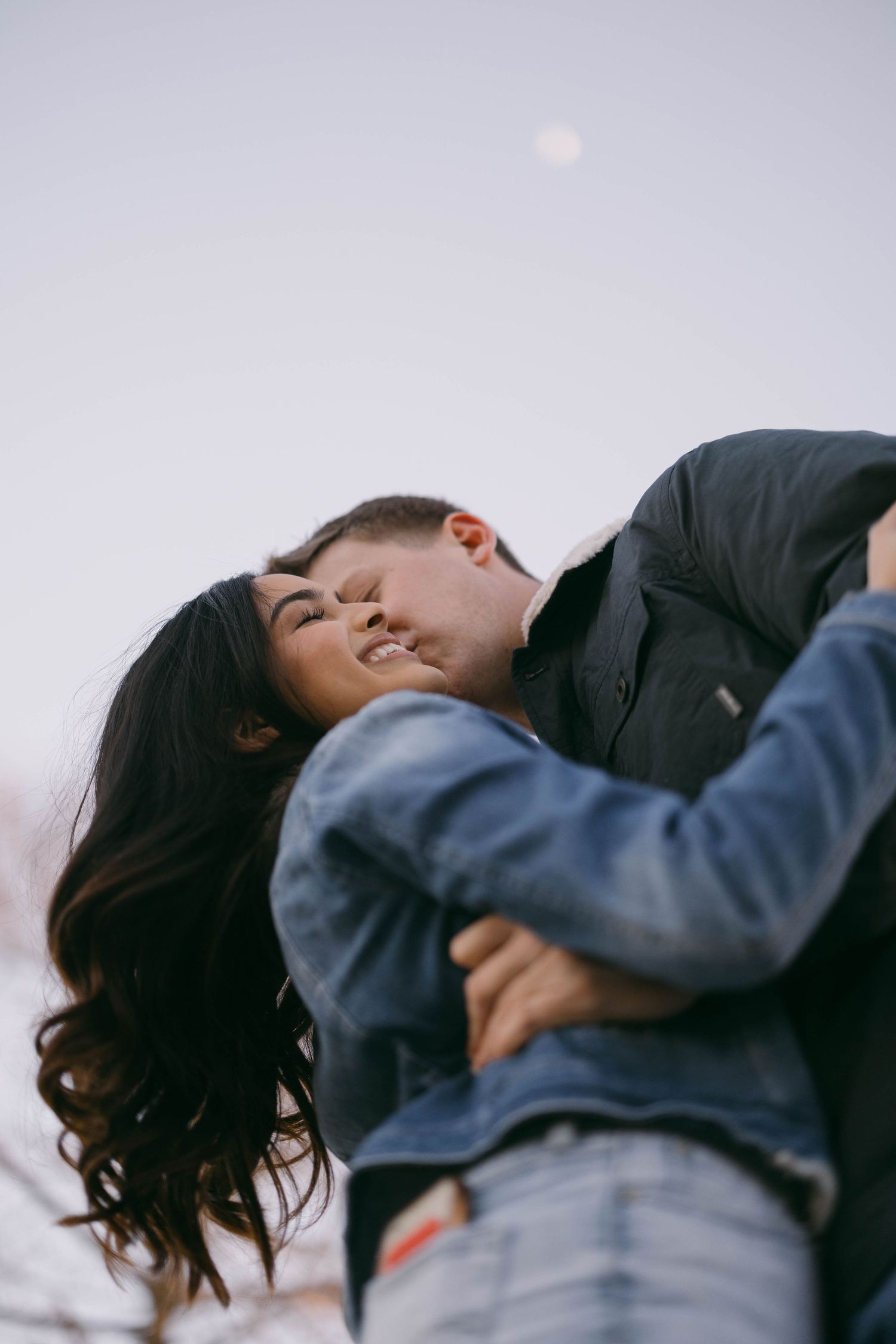 Close-up of couple sharing tender moment outdoors.