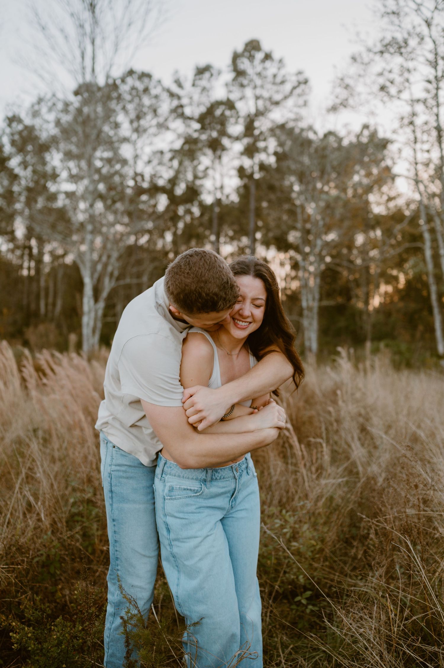 Couple wrapped up in each others arms in a field in Yulee, Florida