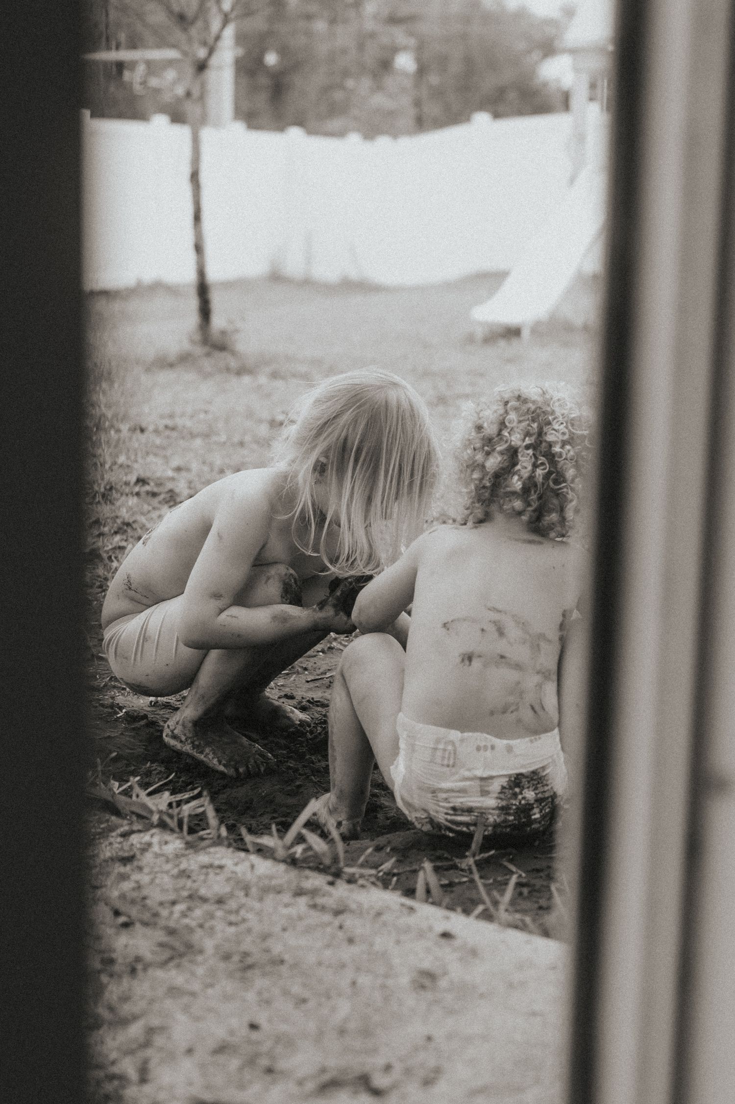 Life style in home relaxed photo of two children playing in mud in Fernandina Beach, Florida