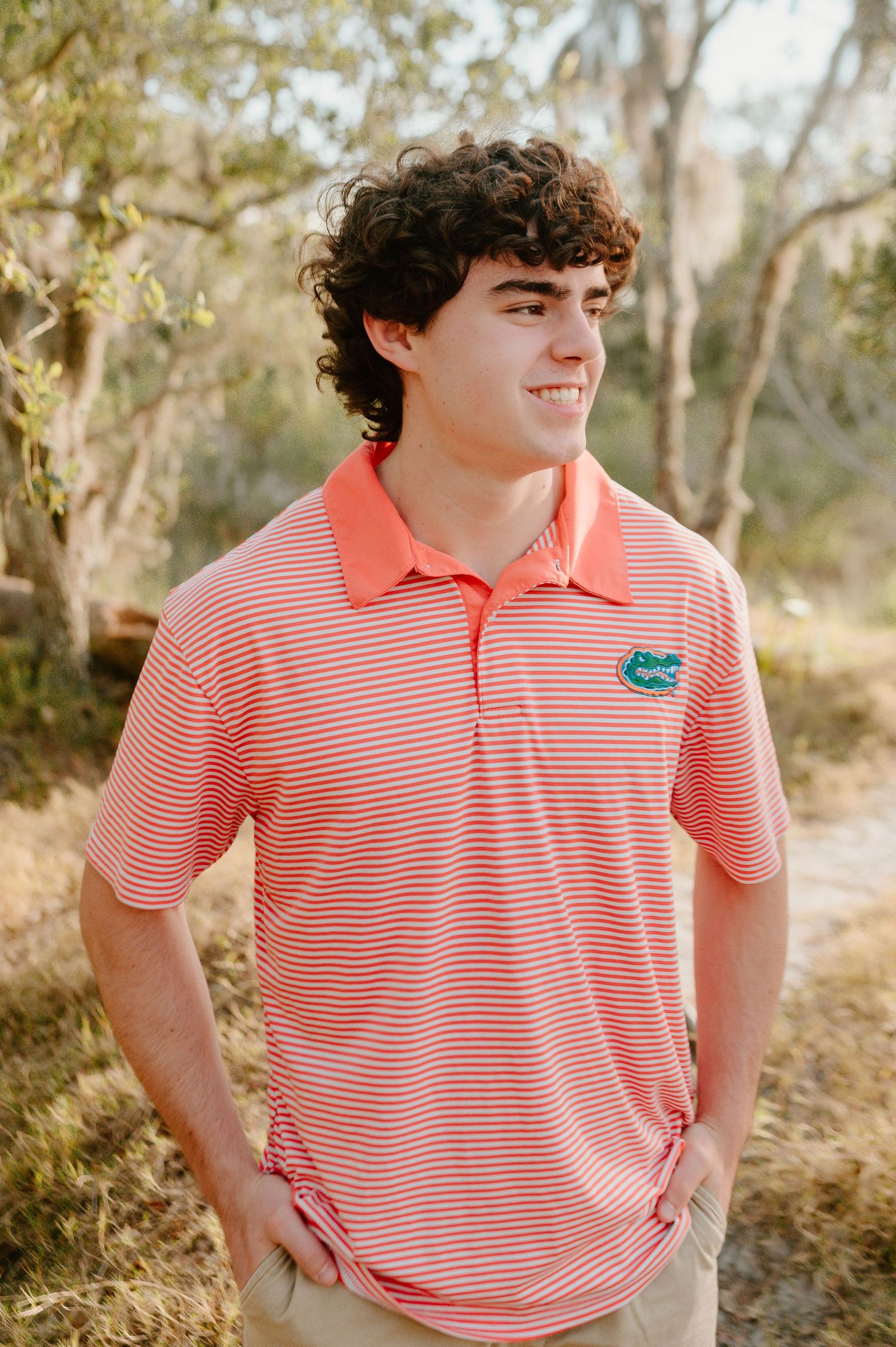 Boy senior photography session at Fort Clinch in Fernandina Beach, Florida. Senior boy looking to the right in a University of Florida shirt