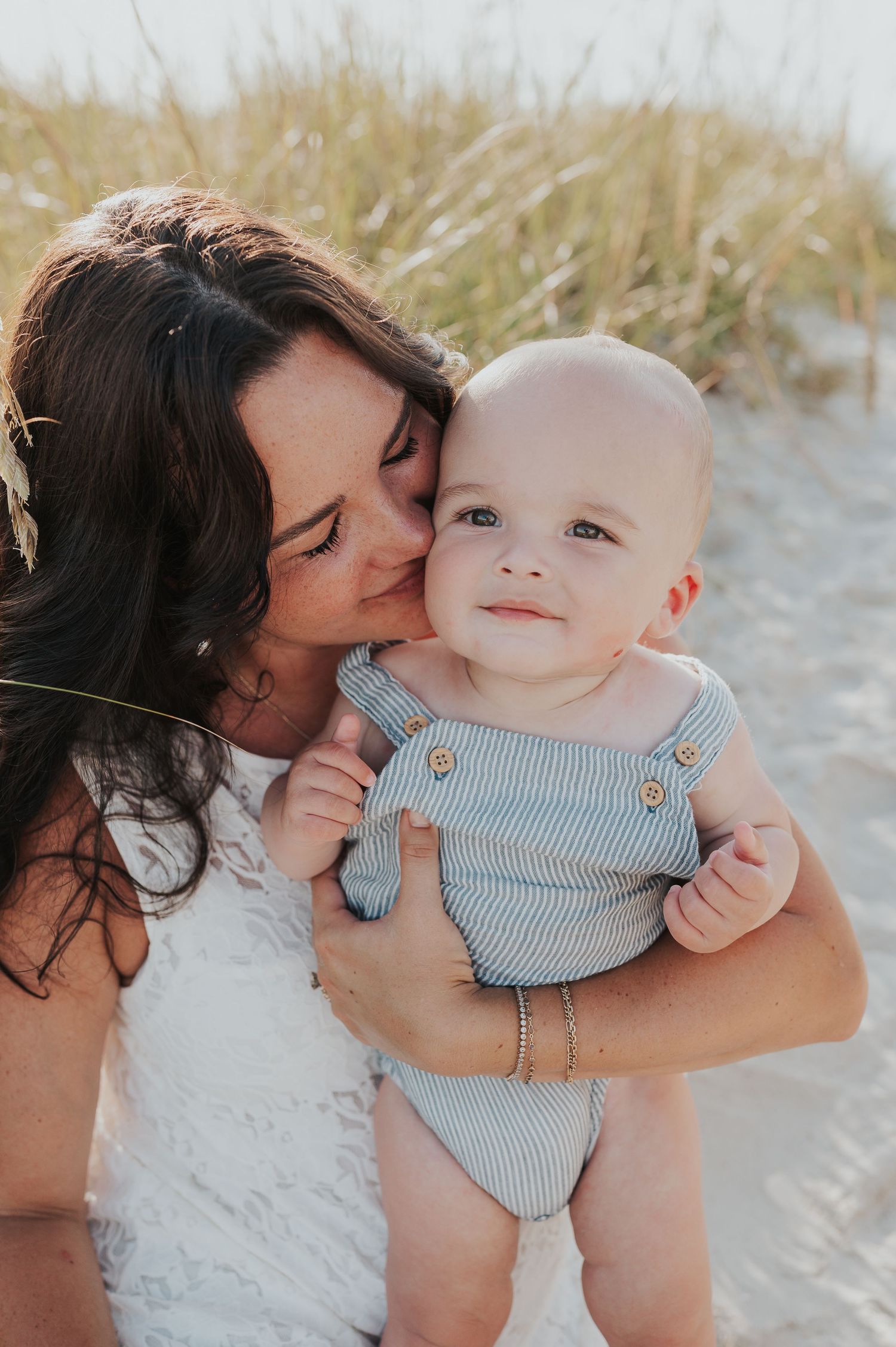 Mother snuggled up to baby boy on beach in Fernandina Beach Florida