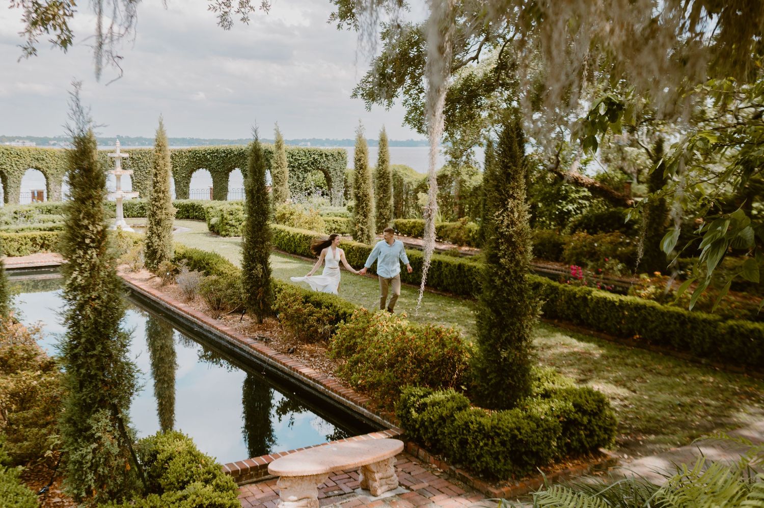 Documentary style photography for couple running through Cummer Museum Gardens in Jacksonville, Florida