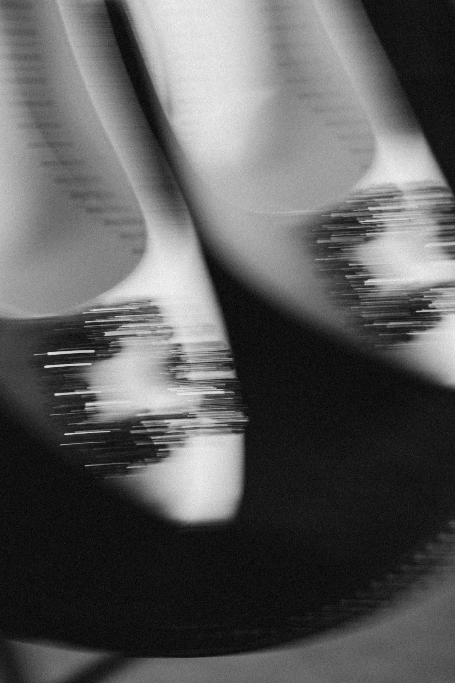 Abstract black and white close-up of spinning vinyl records with motion blur effect.