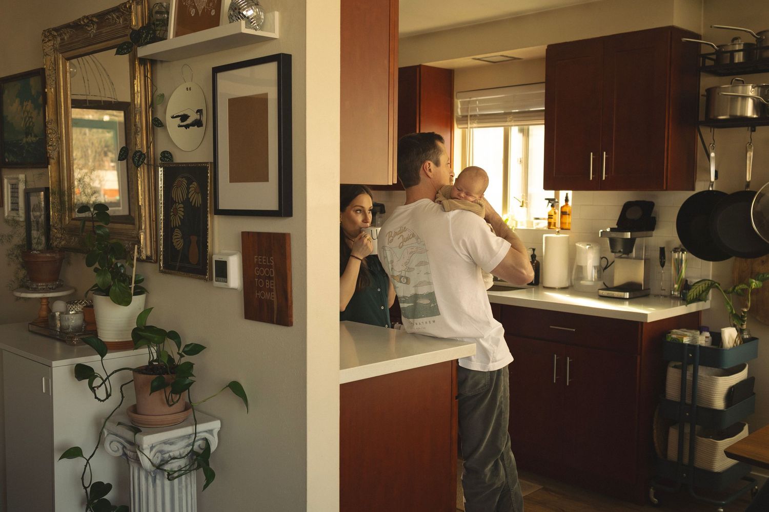Panoramic shot of spacious kitchen with stainless steel appliances and dark wood cabinetry.