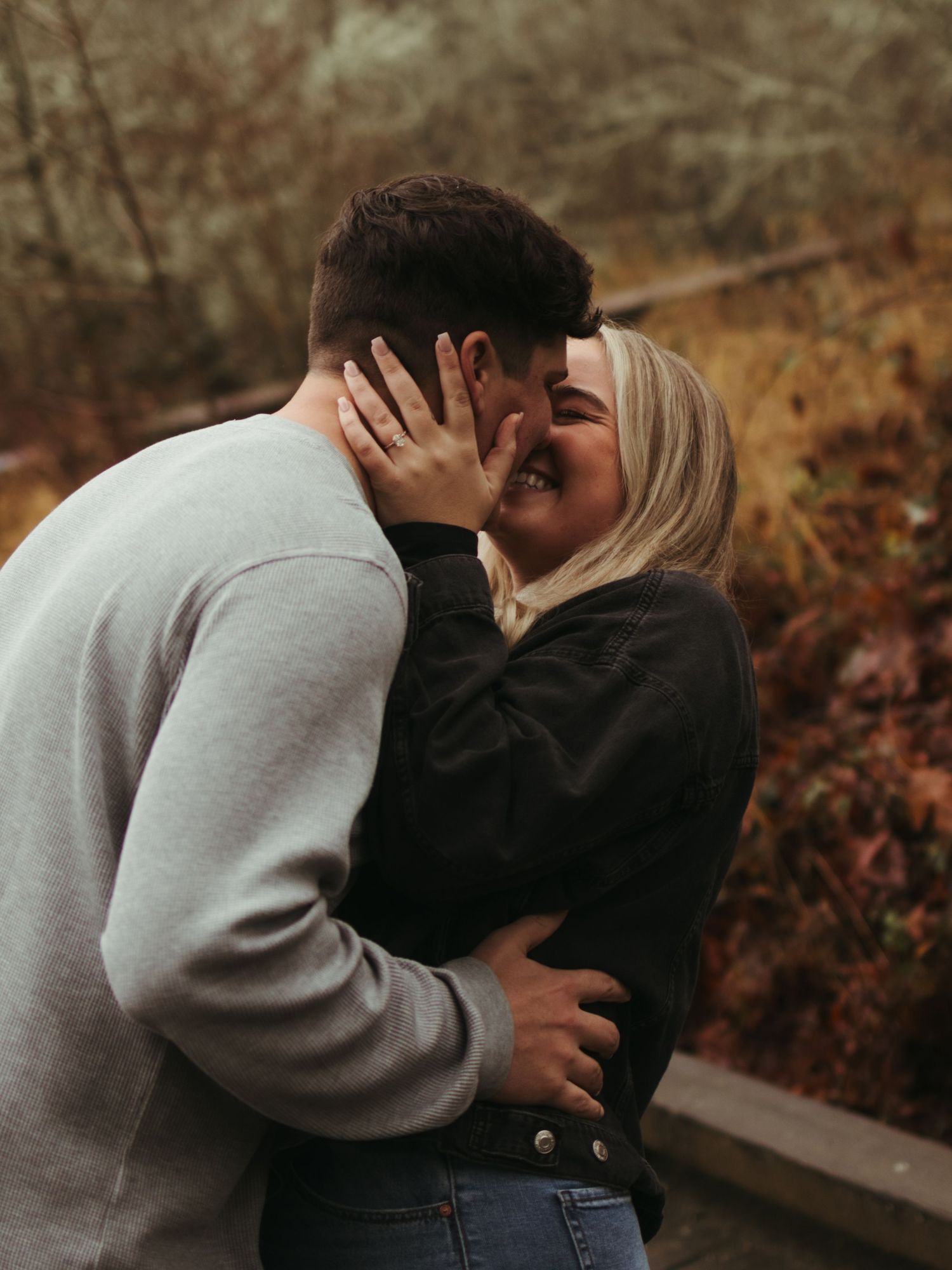 A romantic autumn photoshoot showing tender embraces and intimate moments between a couple in nature.