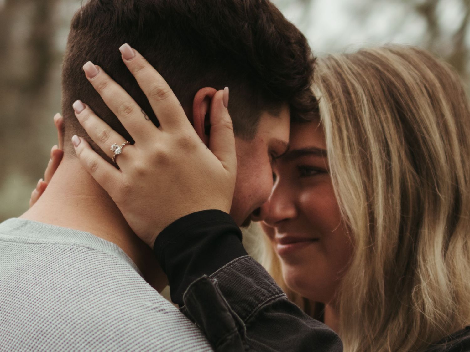 Intimate close-up moments between couple during outdoor photo session.